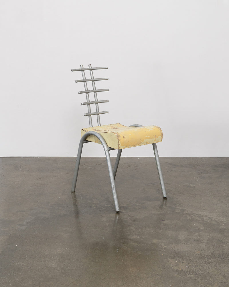 Postmodern prototype chair with yellow foam seat and metal ladder backrest