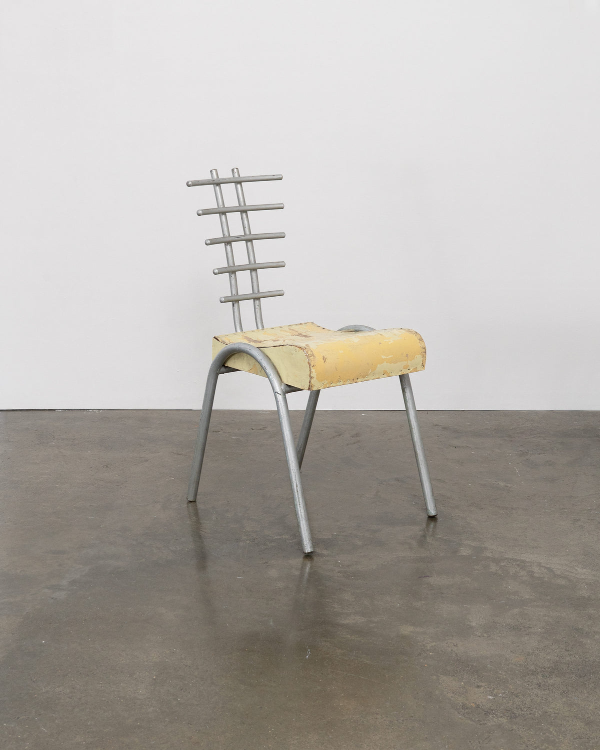 Postmodern prototype chair with yellow foam seat and metal ladder backrest