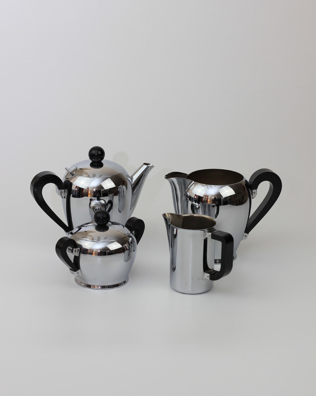 Italian Tea & Coffee Set — close-up of polished chrome teapot and creamer