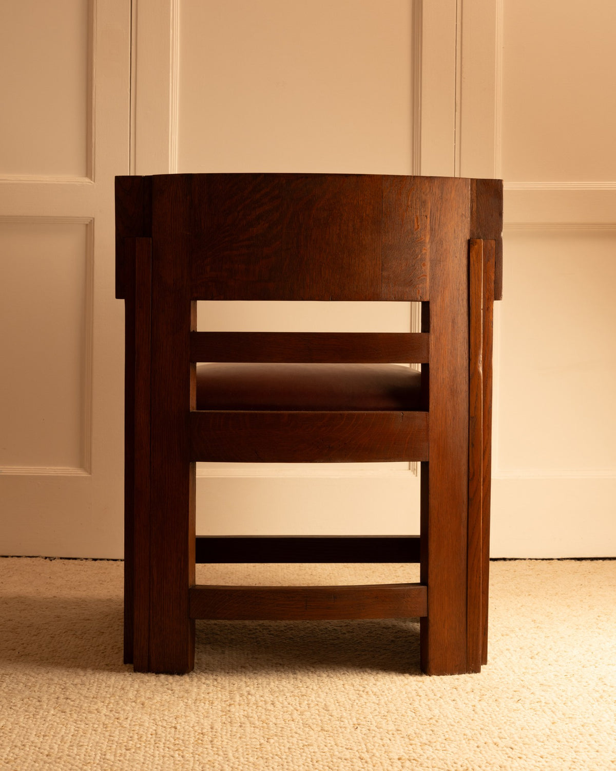Two walnut wood armchairs stacked showing clean geometric design