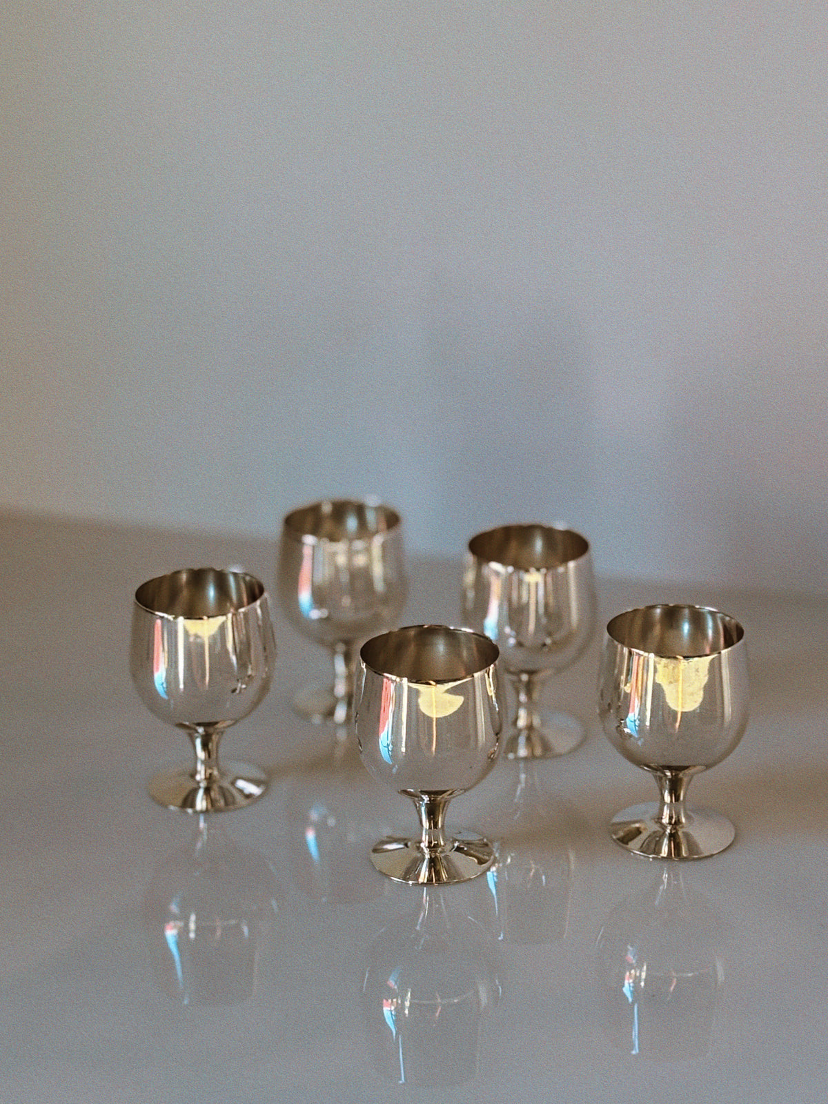 Set of 5 Silver Plated Liquor Cups, 70's Poland — arranged on a reflective surface
