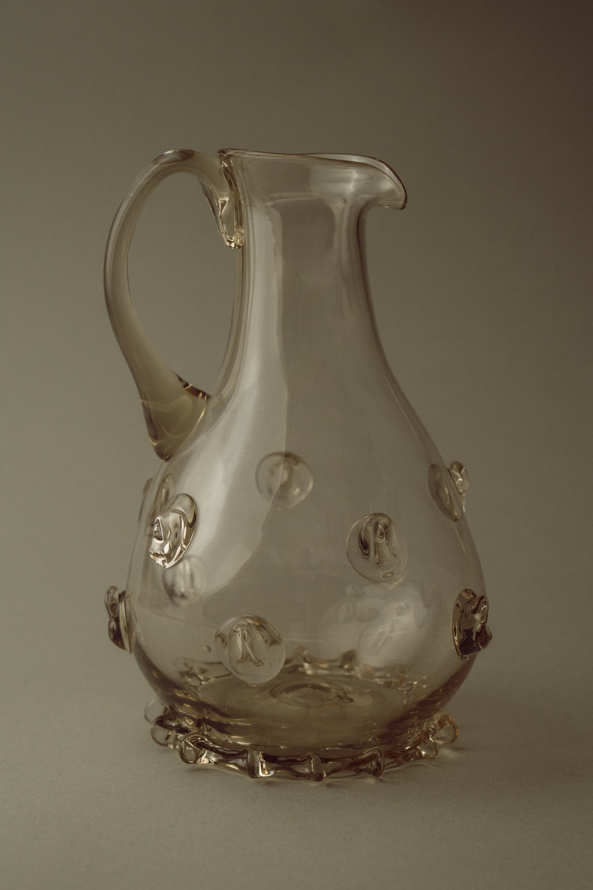 Contemporary Carafes in Glass with ornaments - Mouthblown Collection — side view of clear glass carafe with decorative orbs