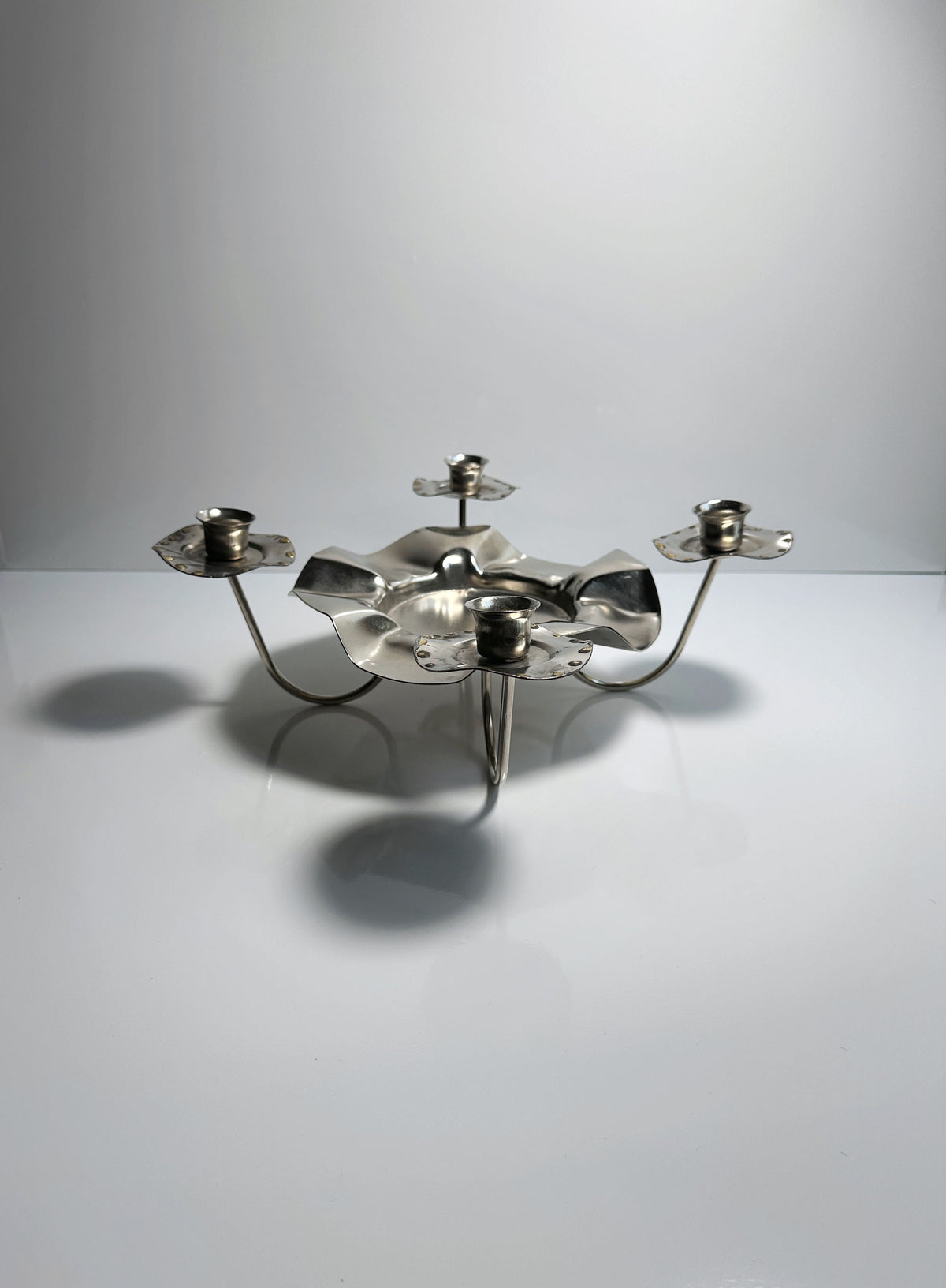 Silver Metal 1960s Candleholder — angled view on white surface