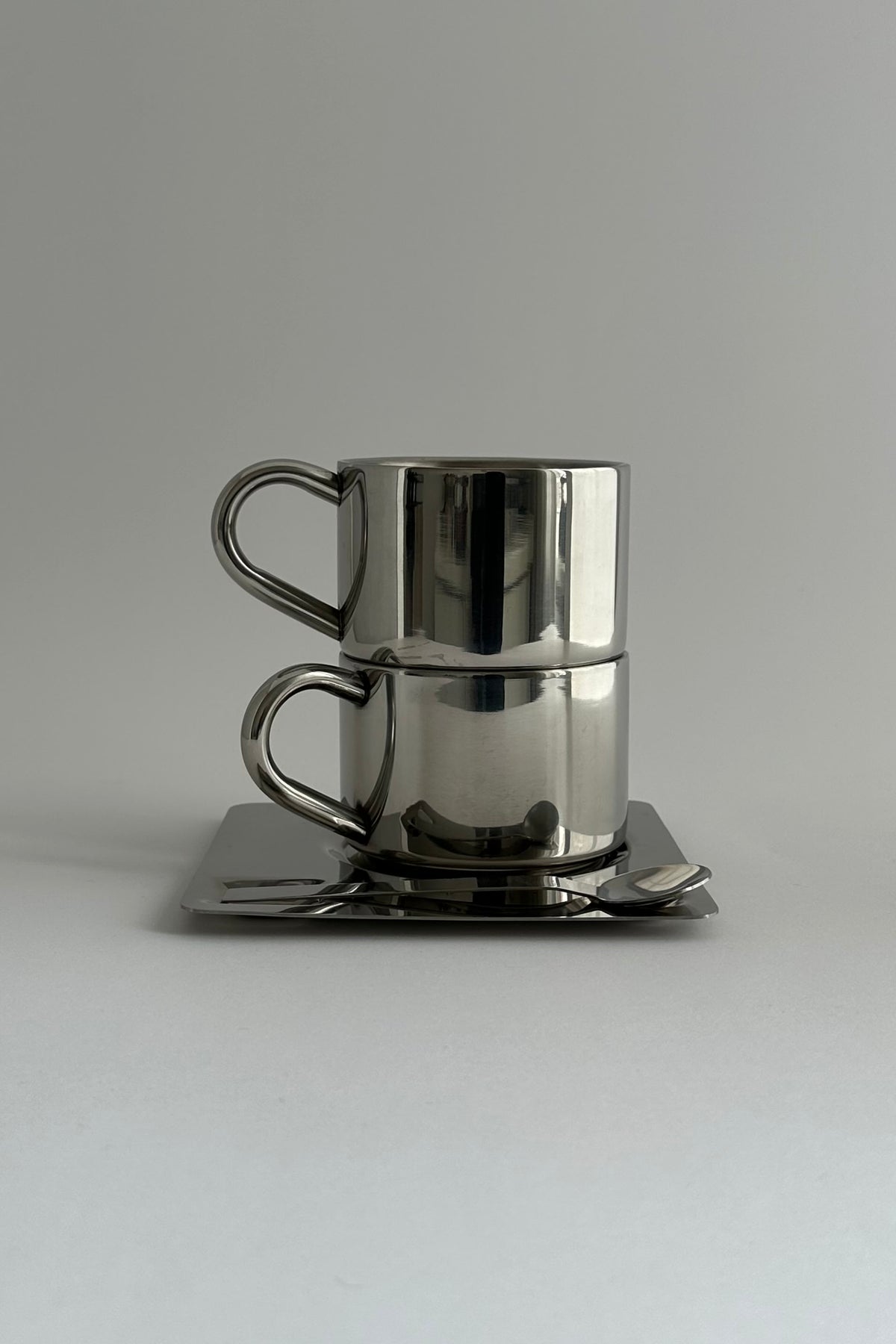 'HEDONISM' stainless steel cup with saucer — alternate view