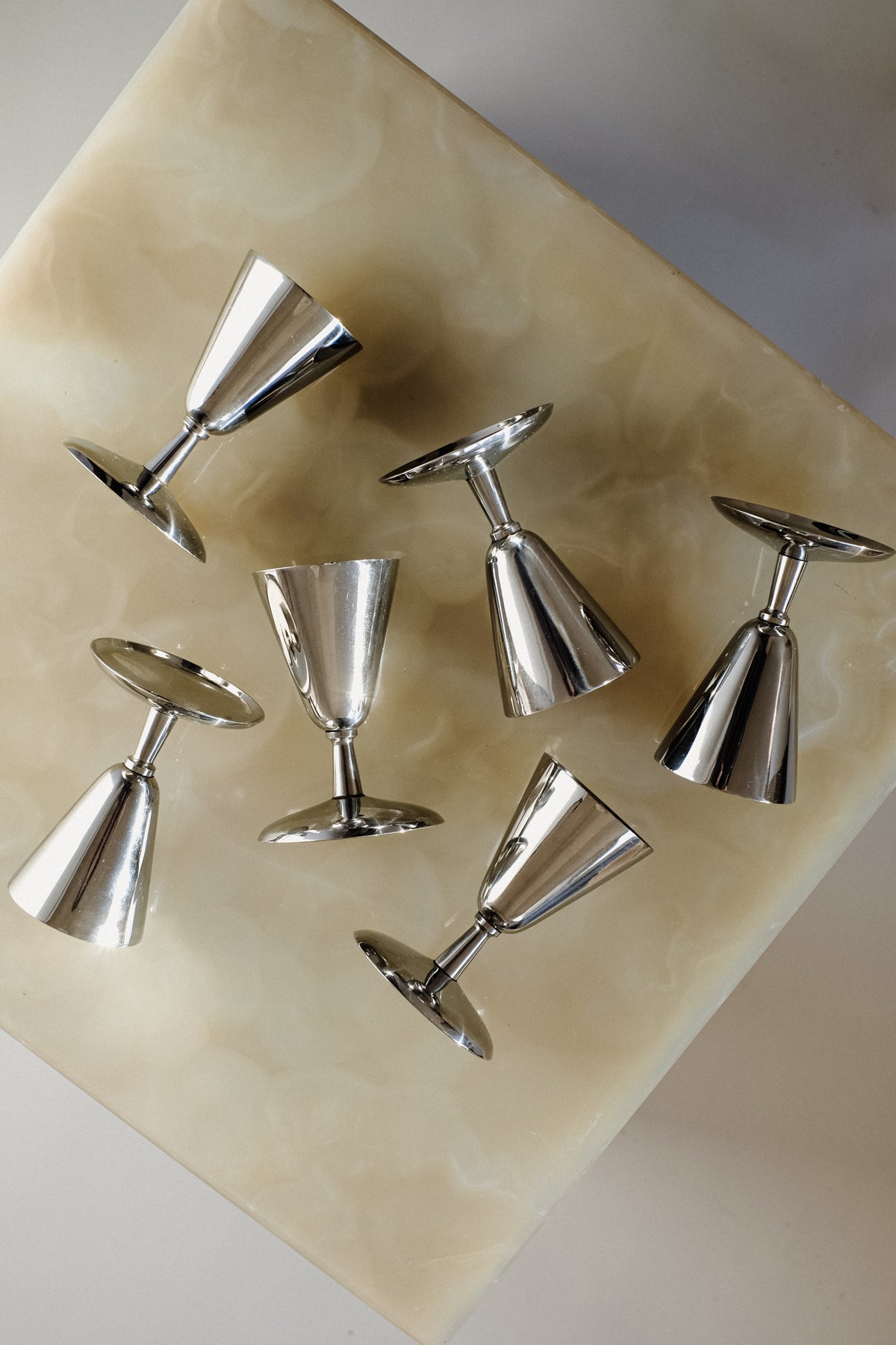 Set of 6 Coupes — top view of polished metal finish on marble surface