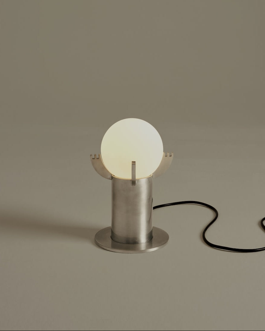 Modern Mago table lamp with glowing sphere and brushed steel base