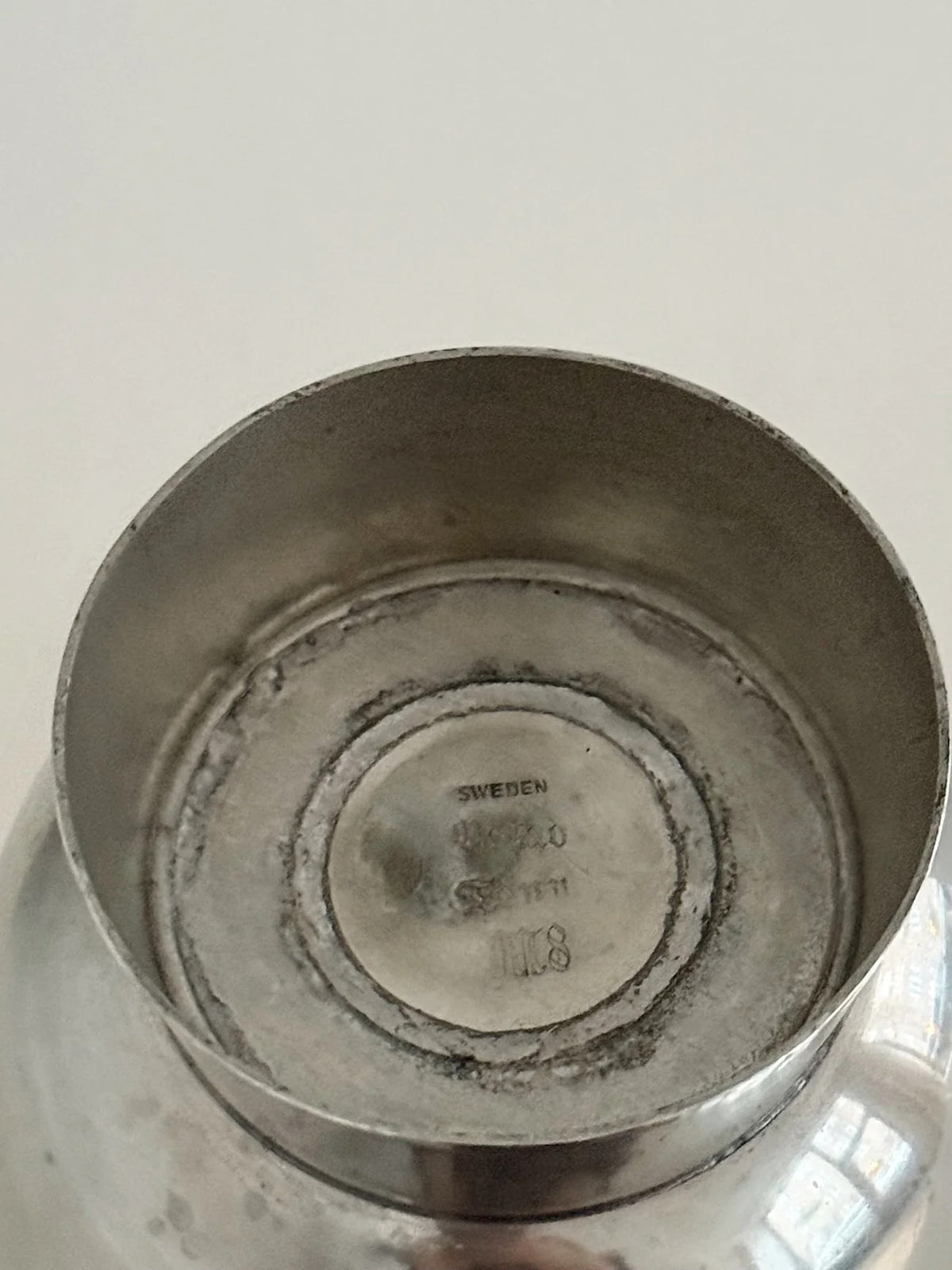 1930s Pewter Vase with Figurative Relief — interior view showing base markings