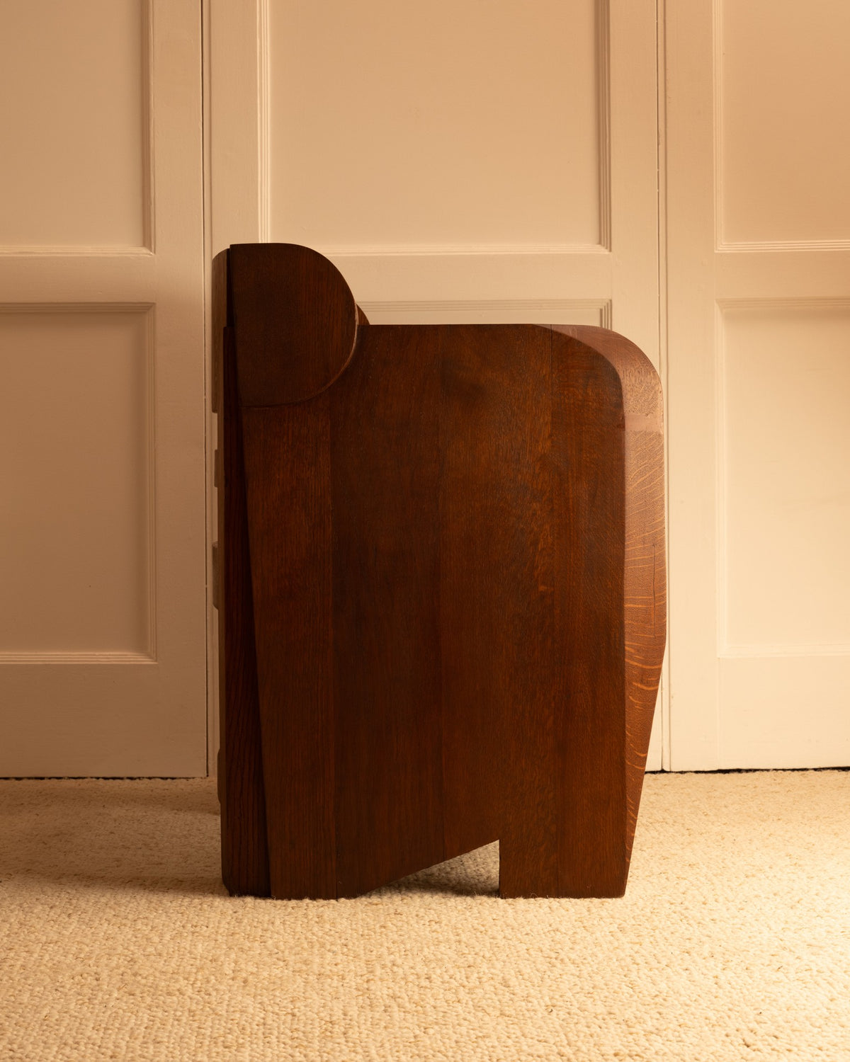 Modern walnut wood armchair with curved geometric form