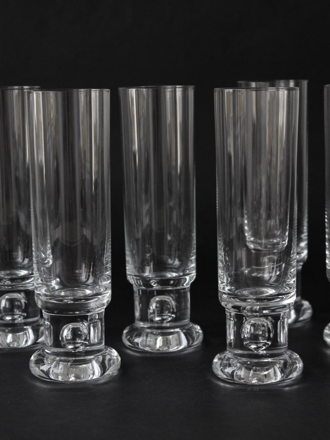 Clear Tapio Wirkkala bubble base tall drinking glasses detail view