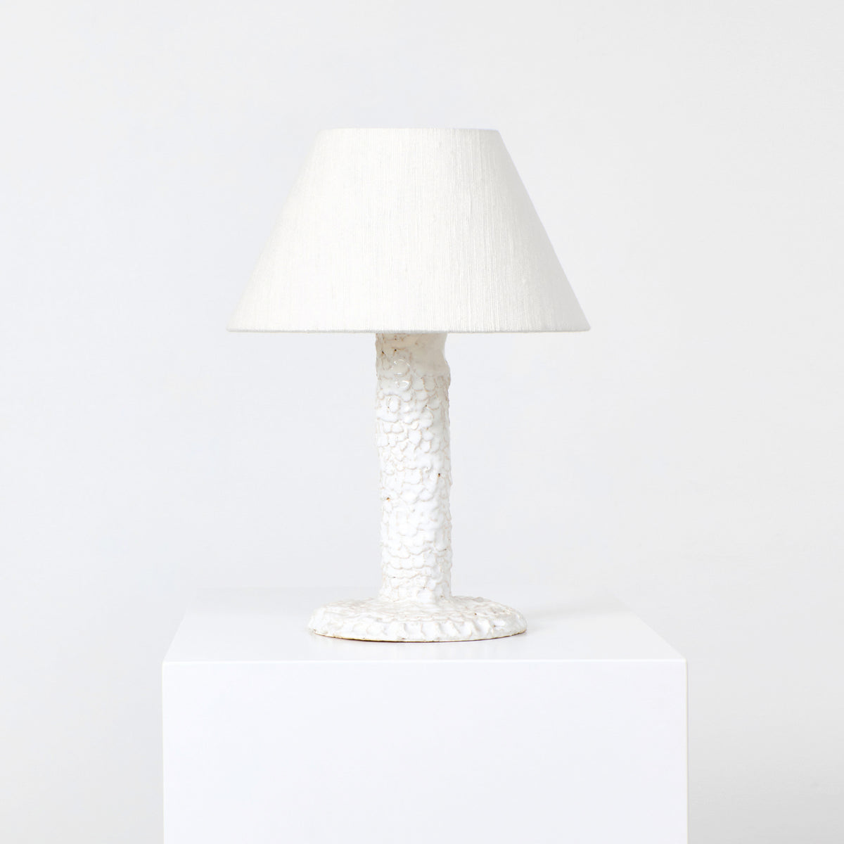 Casa Bedside Light — white textured ceramic lamp on pedestal