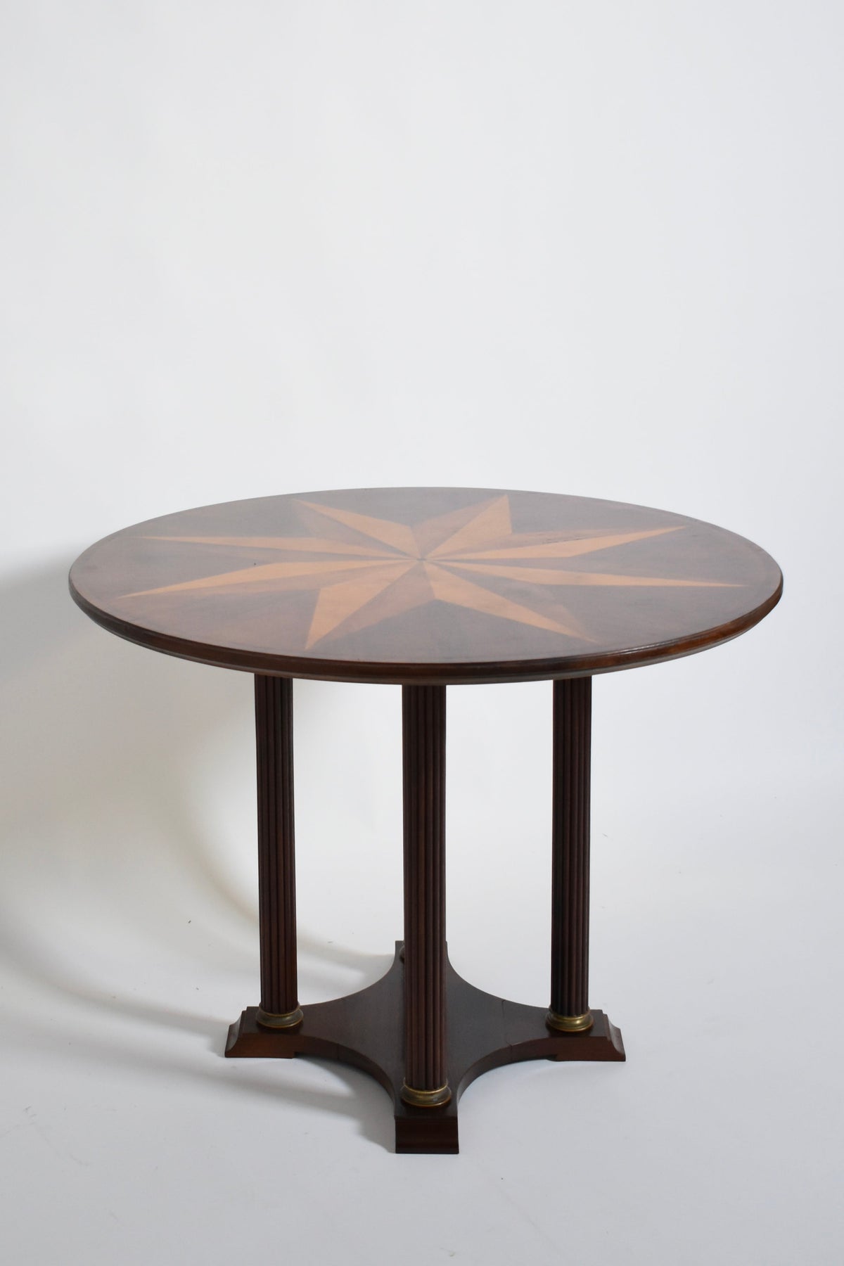 Neoclassical Star Marquetry Pedestal Table — angled view highlighting wood grain and star design