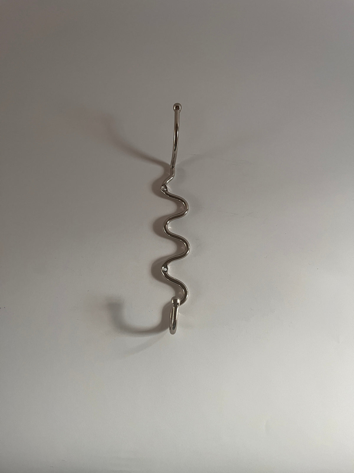 The Meander Hook — top view of silver metal design