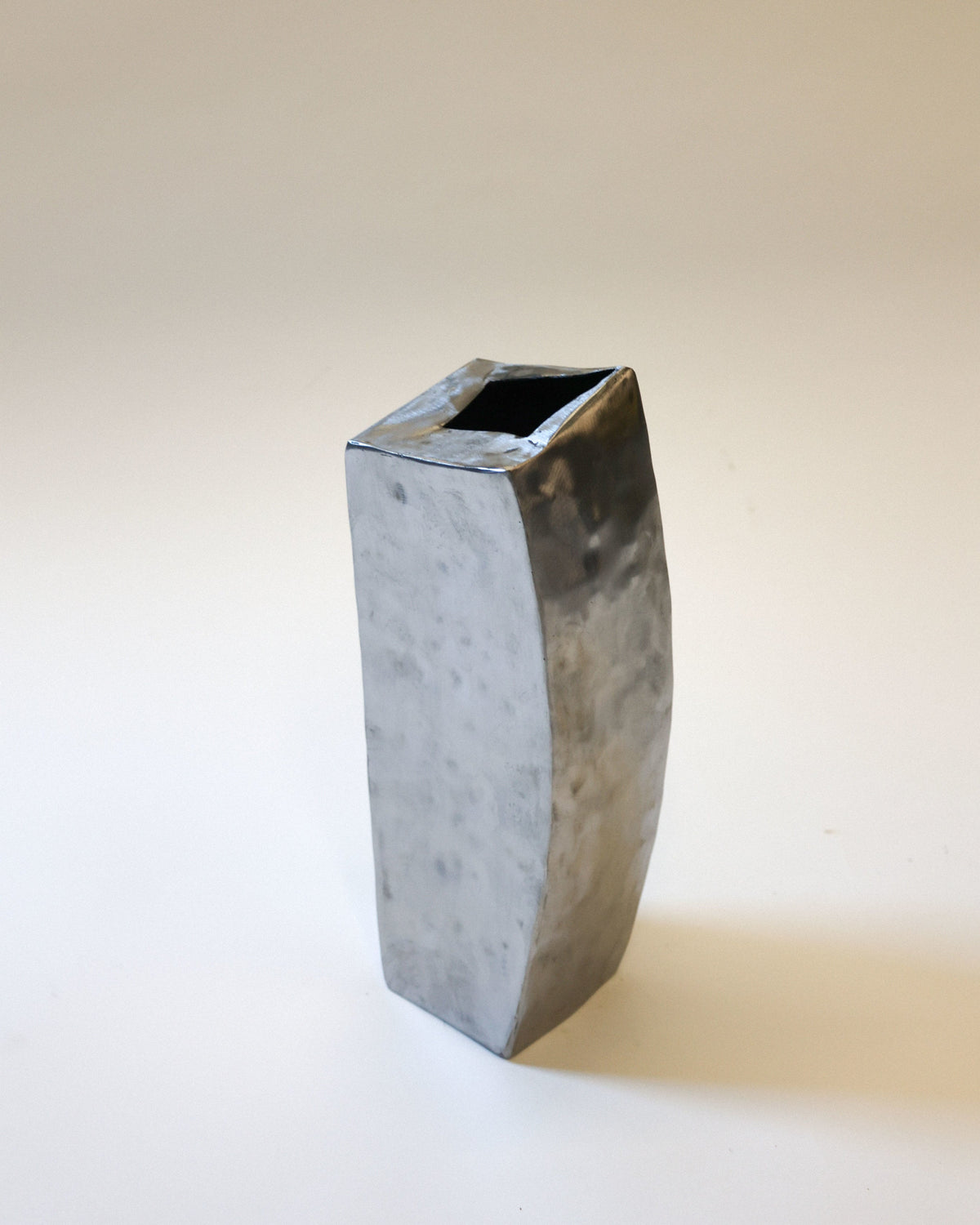 Hammered steel vase profile view showing textured metallic finish
