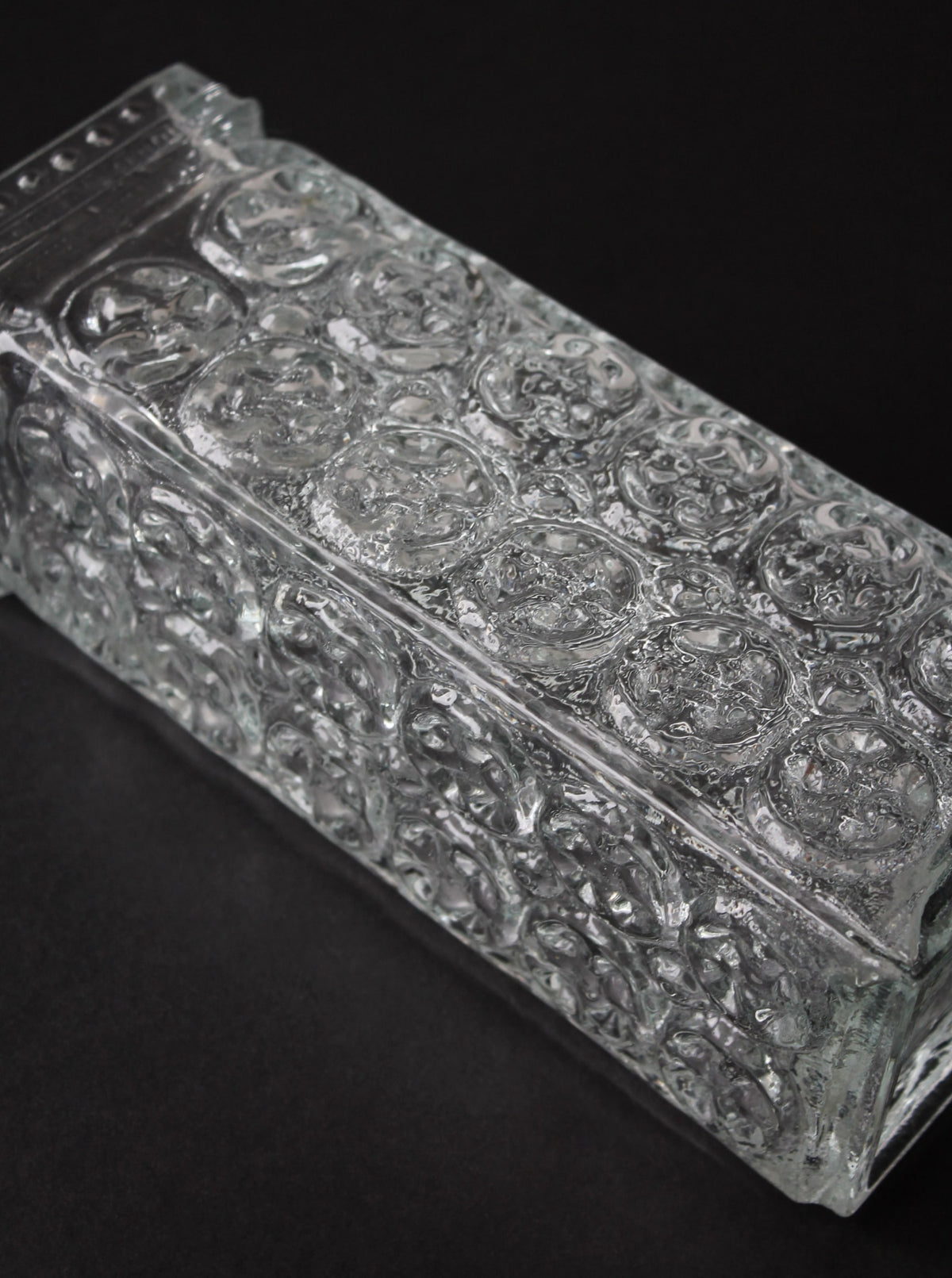 Close-up detail of pressed glass patterns on Czech vase surface