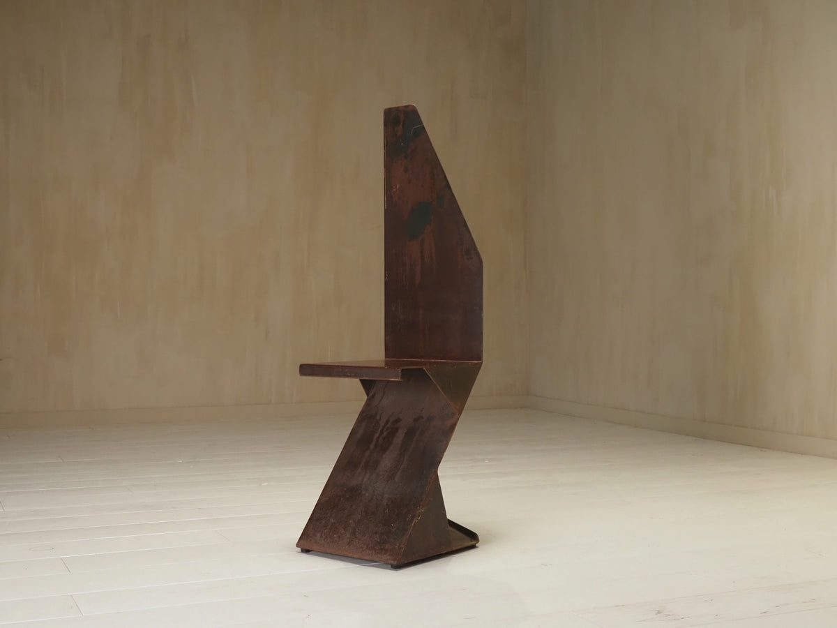 Sculptural postmodernism steel chair — lifestyle setting