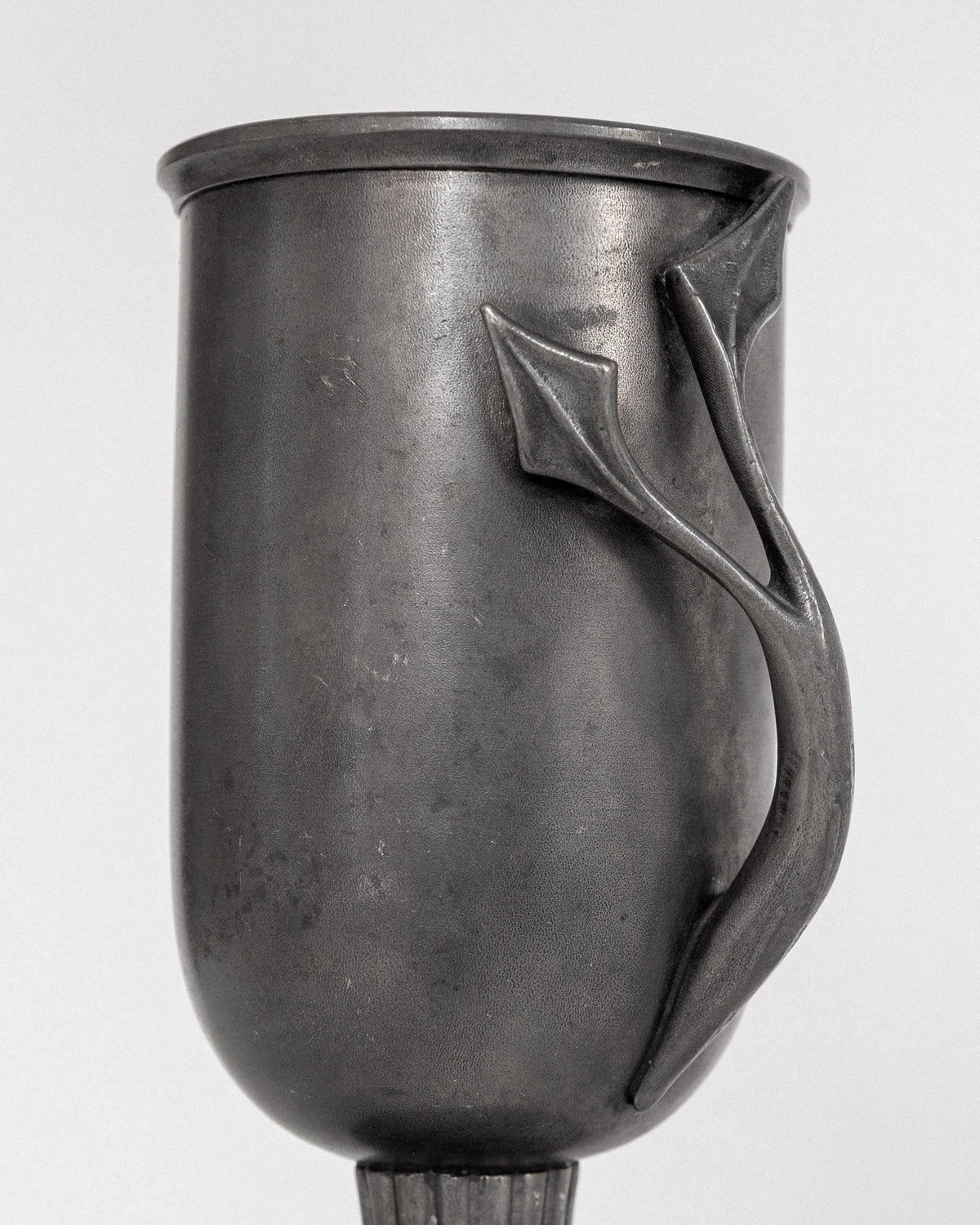 Close-up detail of elegant Swedish pewter vase handle, 1953