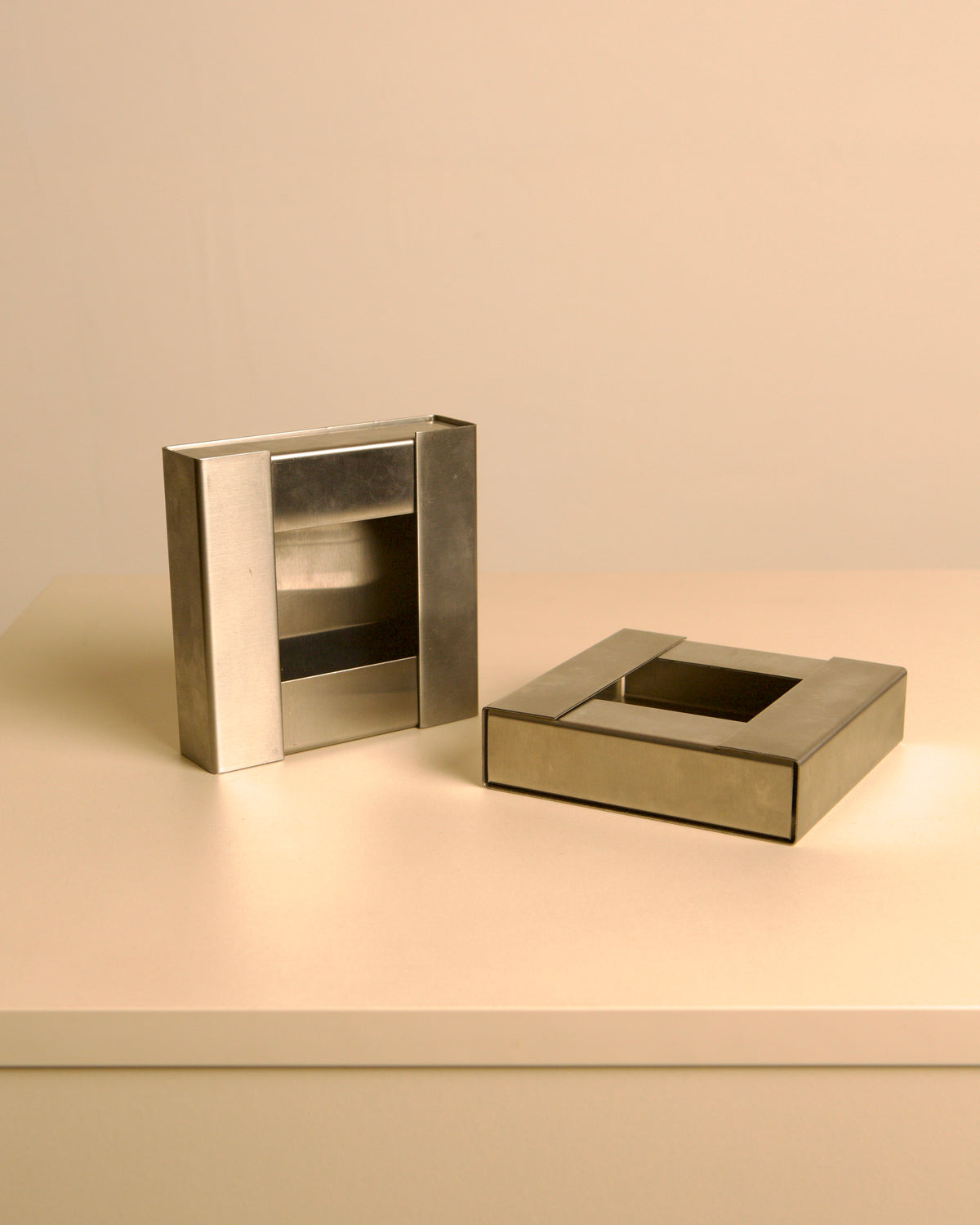 Pair of Italian brushed metal ashtrays by Fontana Arte, 1960s — close-up