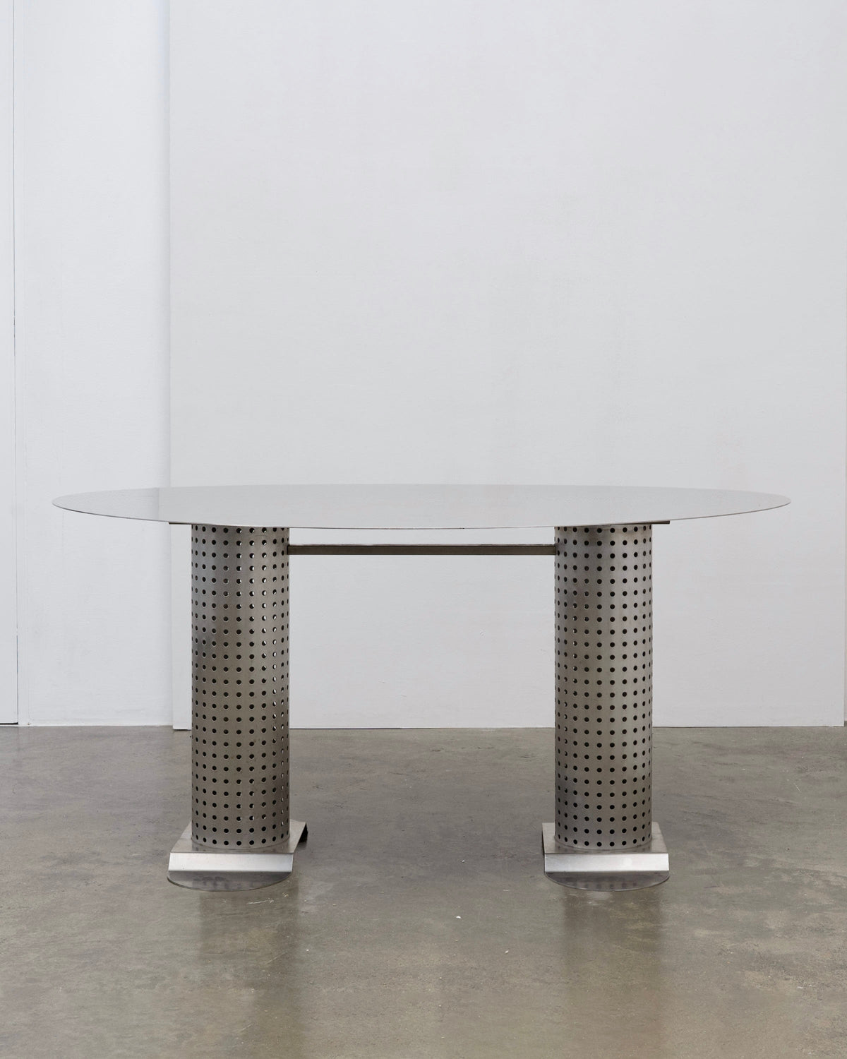 Postmodern Stainless Steel Dining Table, c.1980 — front view with perforated metal legs