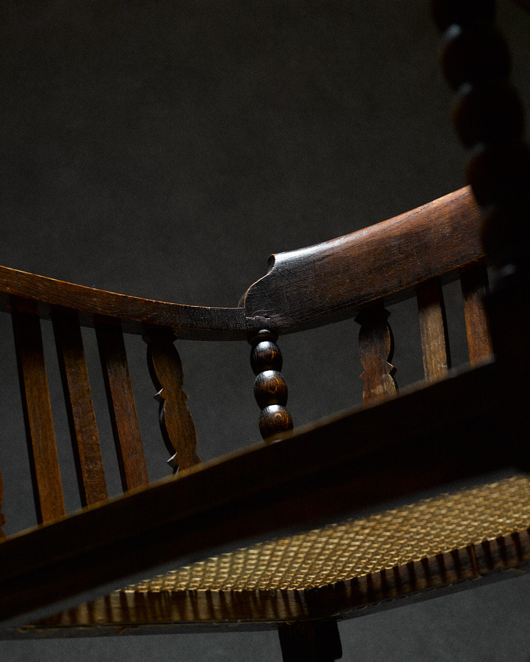 Captains Chair with Cane Seating — side angle highlighting cane seat and wooden frame