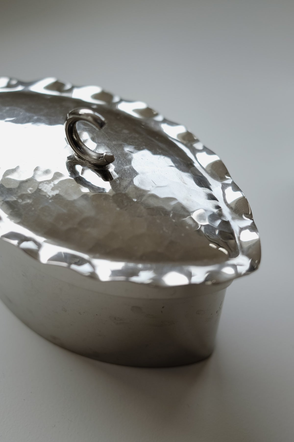 Small Hammered Box — angled view of silver metal surface