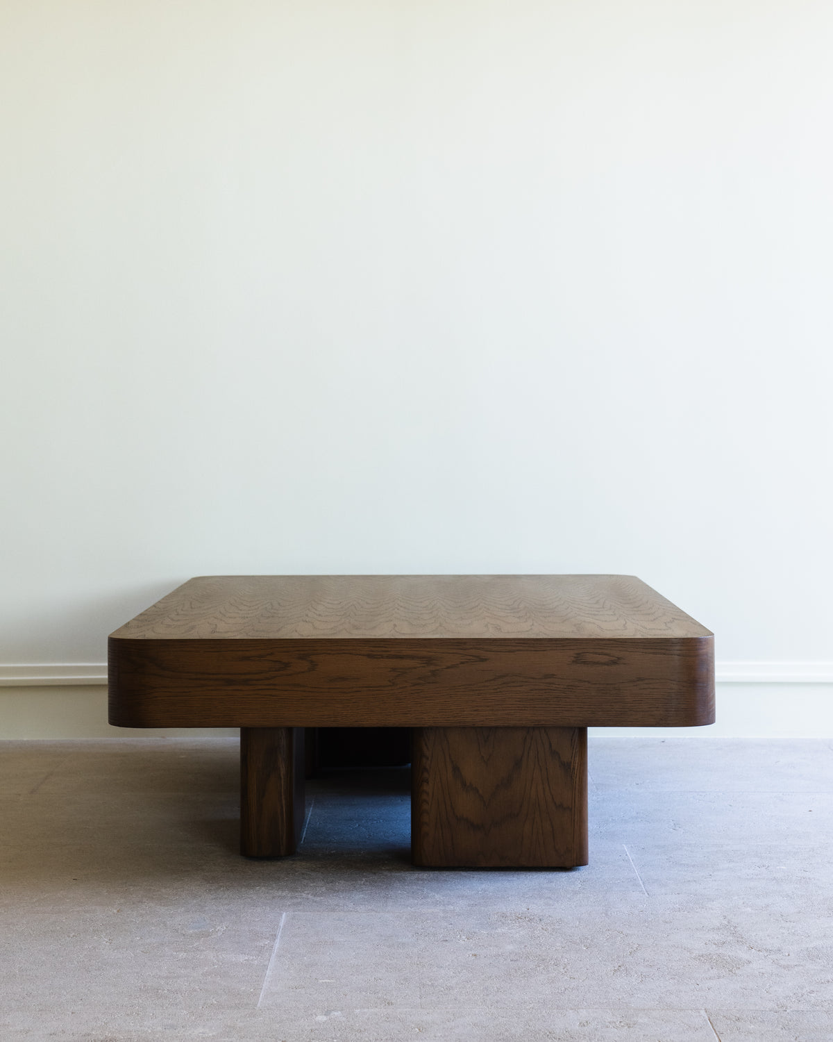 Chalette solid wood coffee table with geometric base by Studio OSKLO