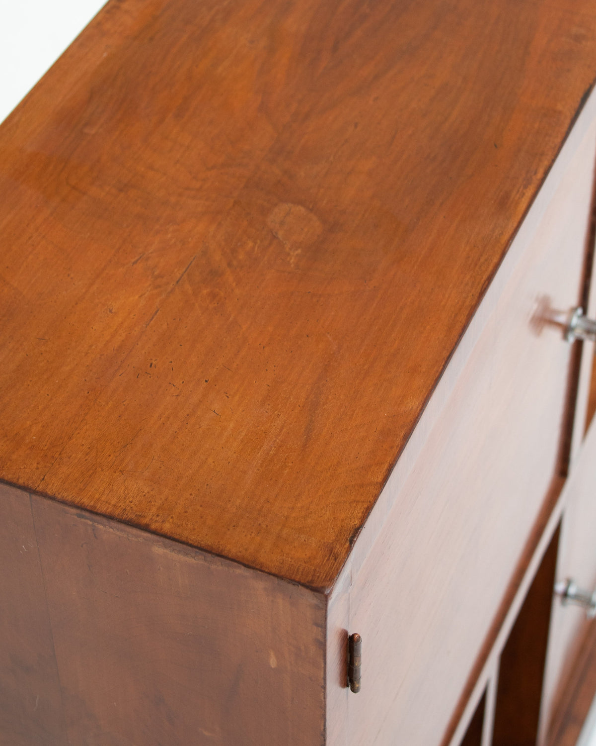 Wood grain detail on Art Deco storage cabinet top with drawers