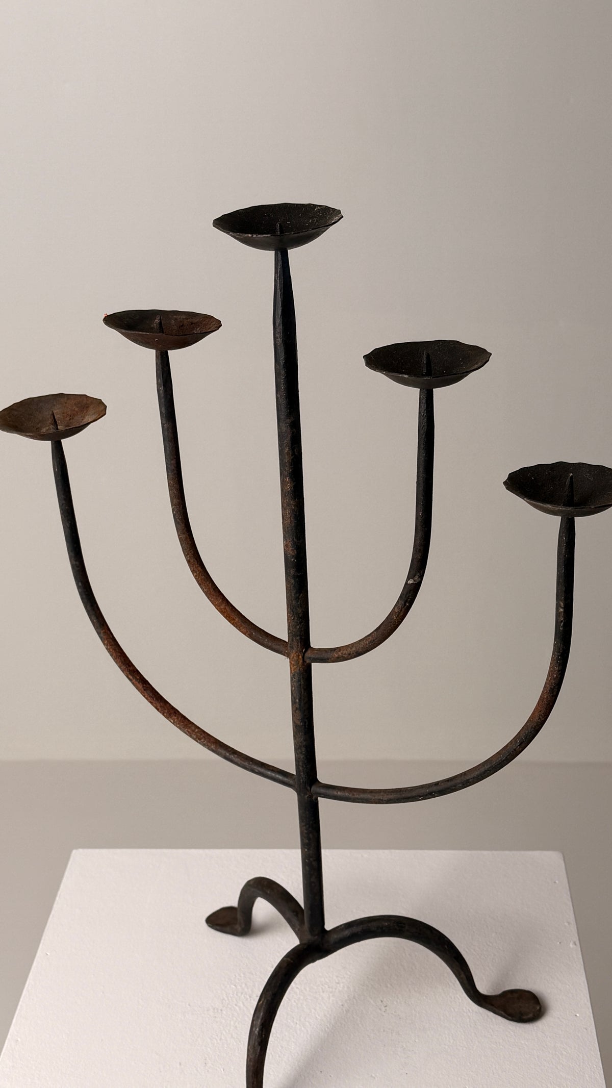 Wrought Iron Candelabrum, France, early 20th century — angled view on white pedestal
