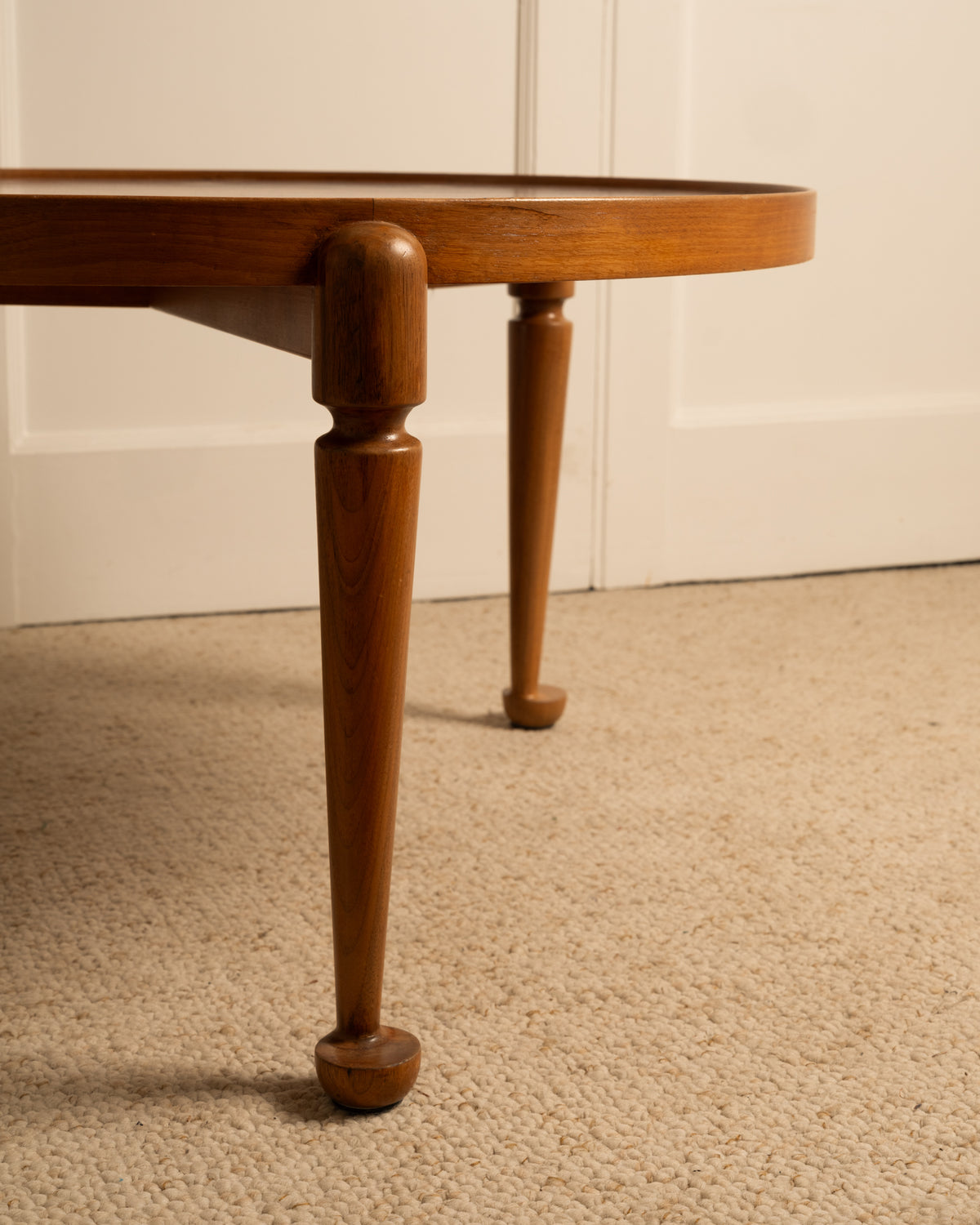 Close-up of turned wood legs on Josef Frank circular side table