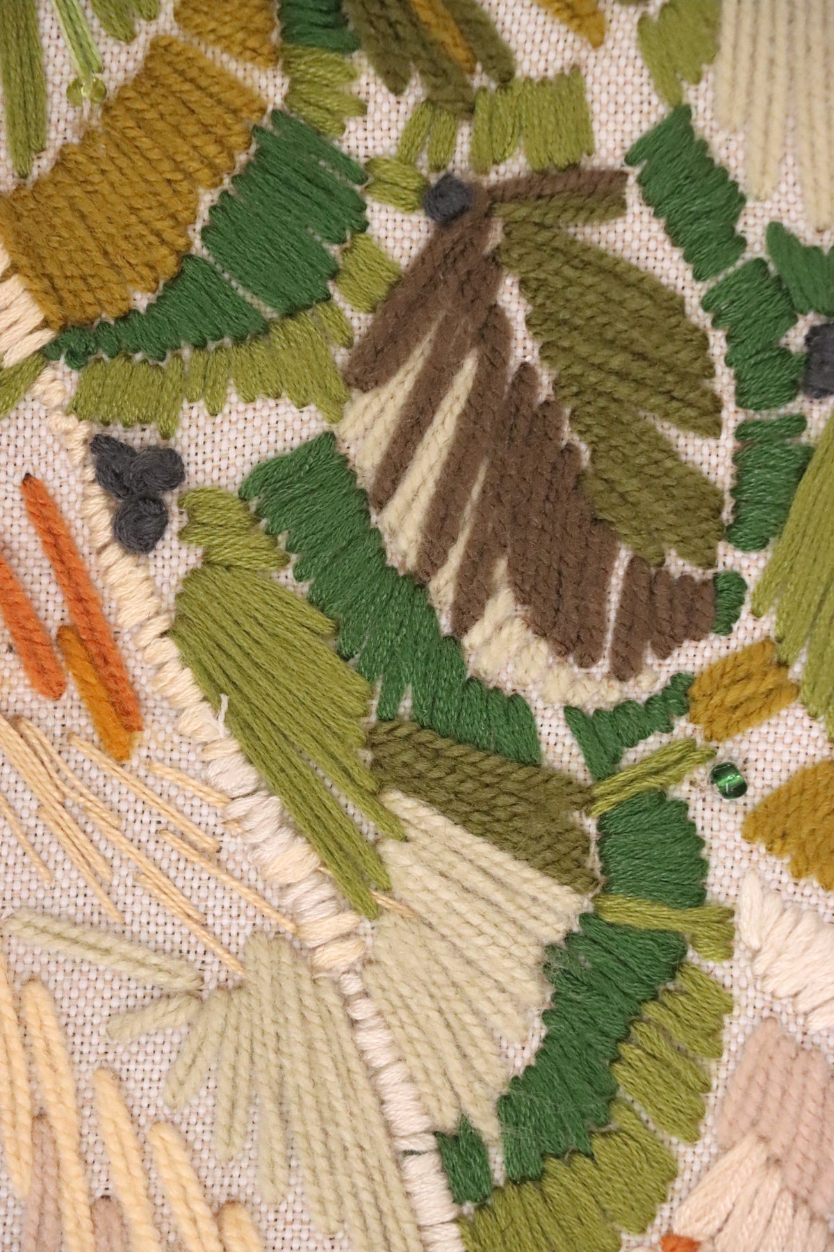 SIMORGH II – Solid Walnut with Hand-Embroidered Upholstery — close-up of colorful embroidered fabric