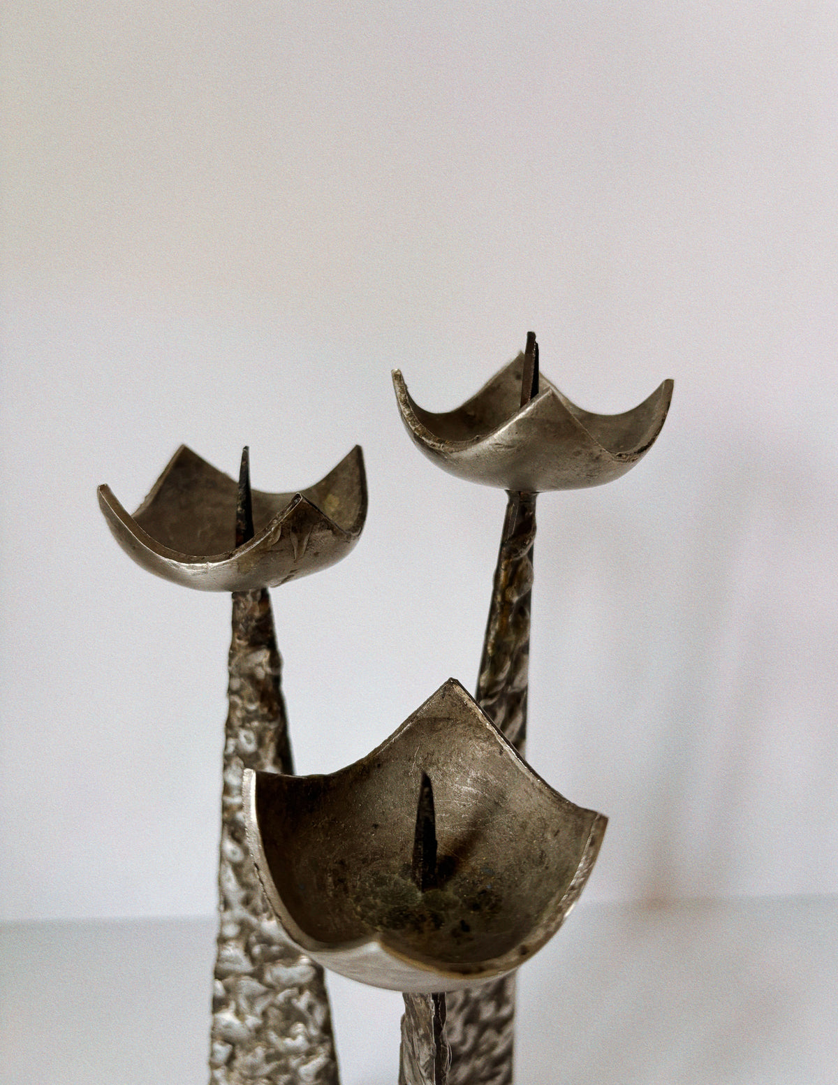 Brutalist Steel 3 Arm Metal Candlestick, Poland Mid Century — close-up of textured steel candle holders