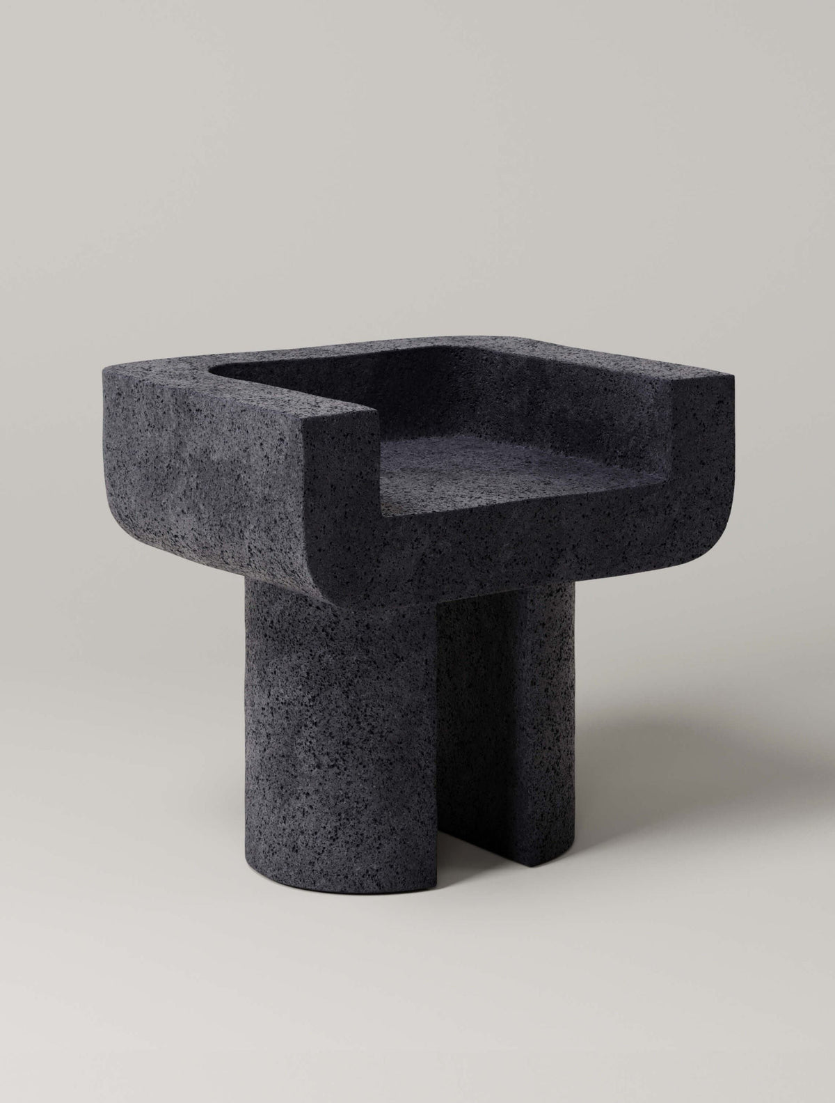 M_001 Chair — side angle showing textured black stone material