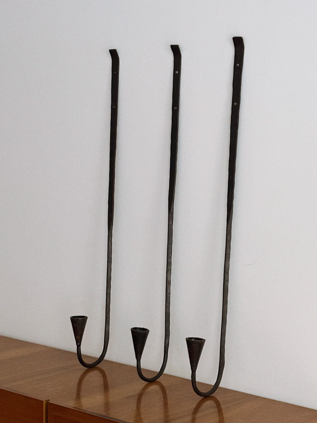 Set of 3 Large Danish Wrought Iron Wall Candlesticks, c. Late 1990s — angled view against white wall