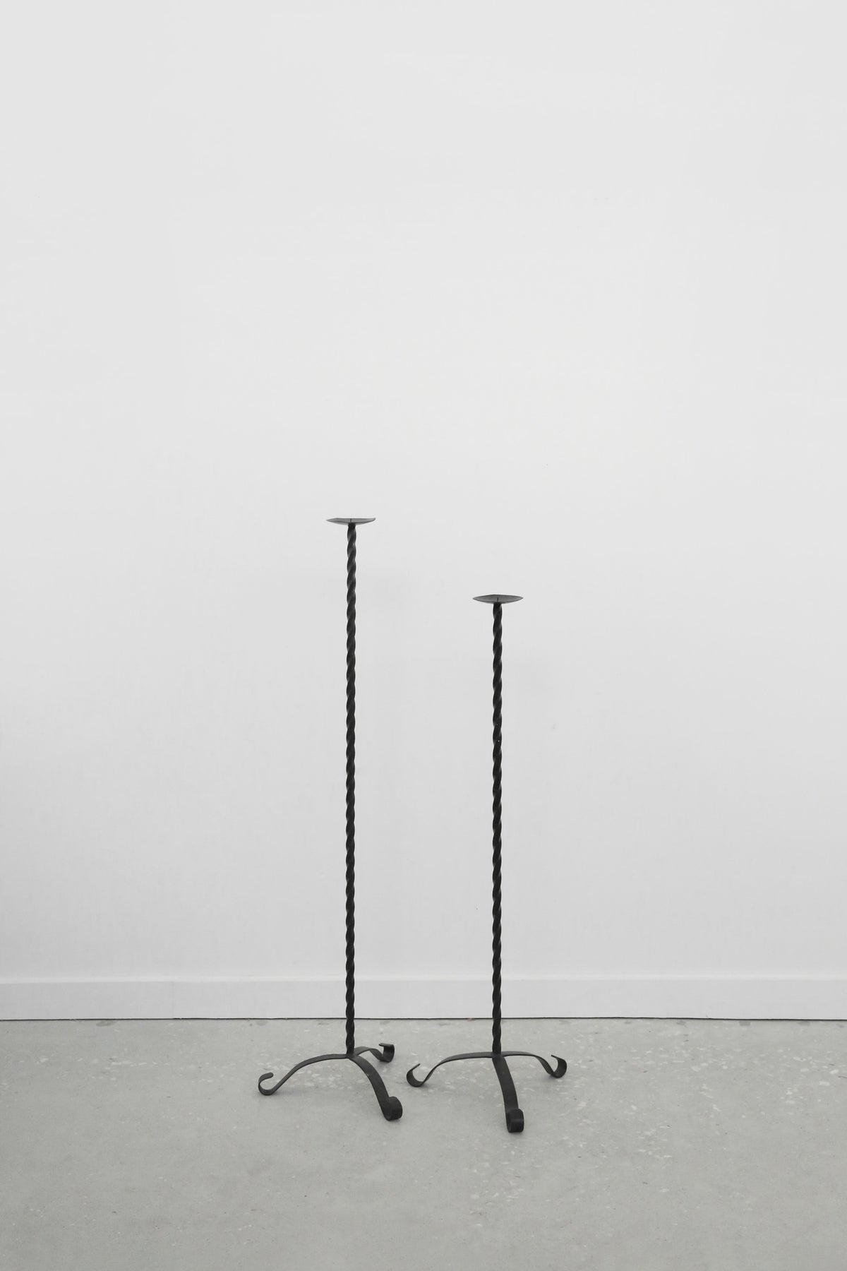 Twisted Iron Floor Candleholder Set — side angle on concrete floor