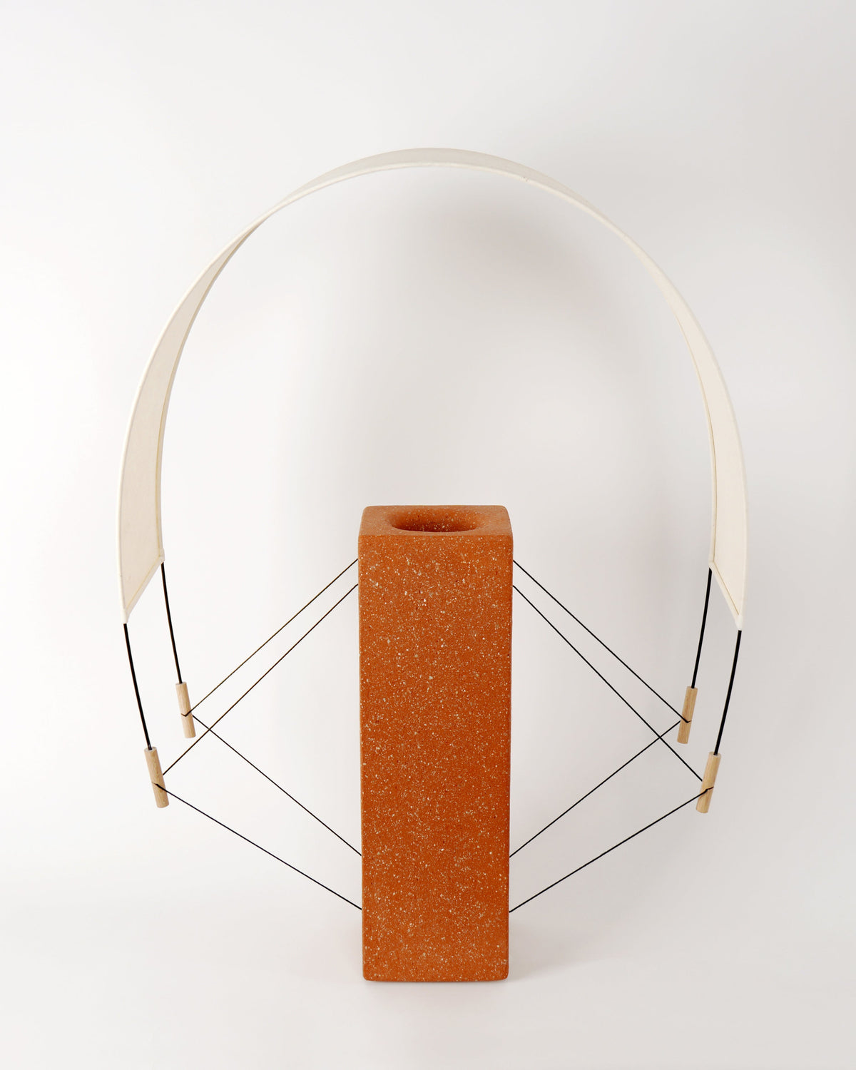 Lumia terracotta table lamp with curved acrylic shade and wire base