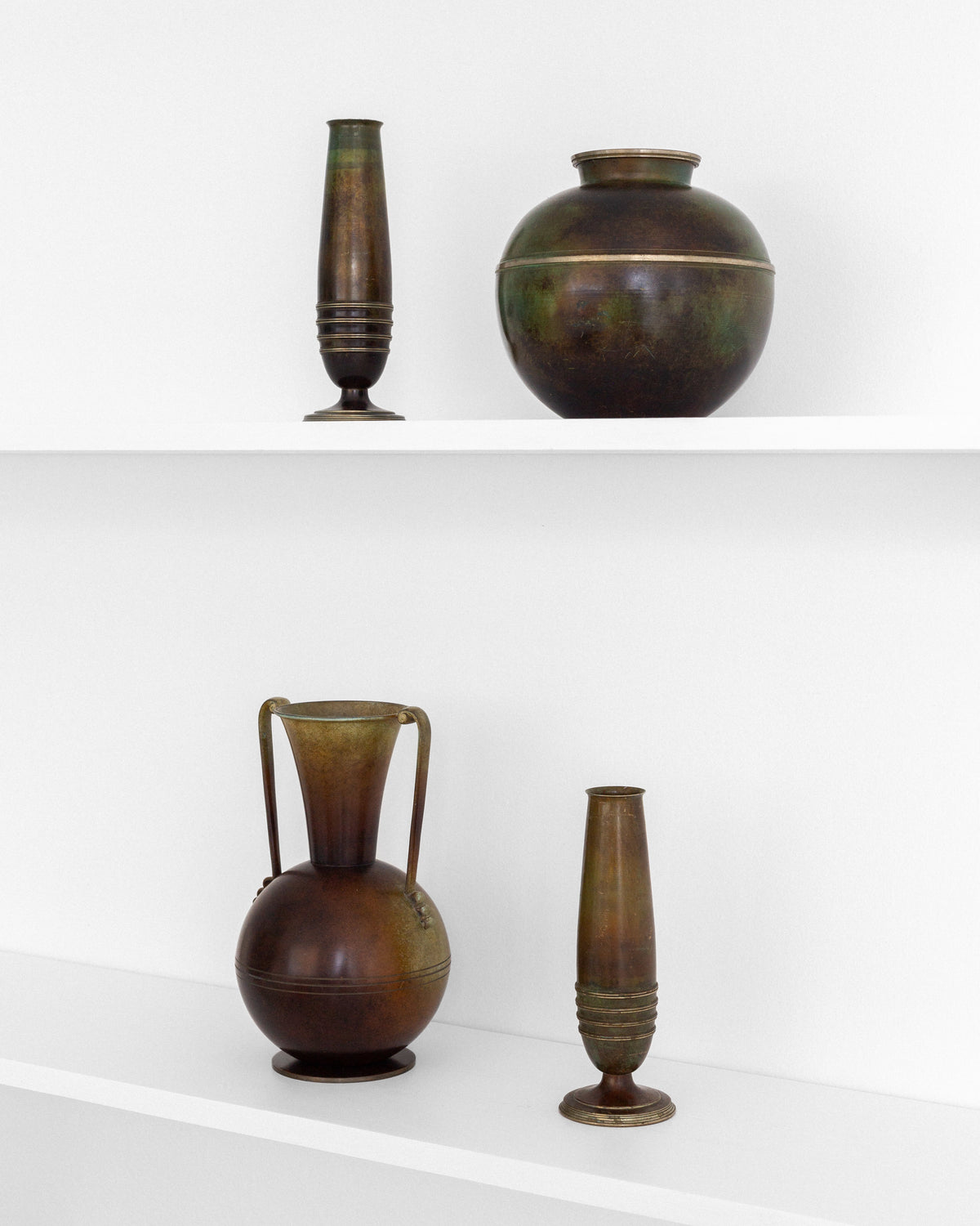 Graceful Art Deco Vase by Ystad-Metall, Sweden, 1930s — side angle on white shelf with vintage brass vases