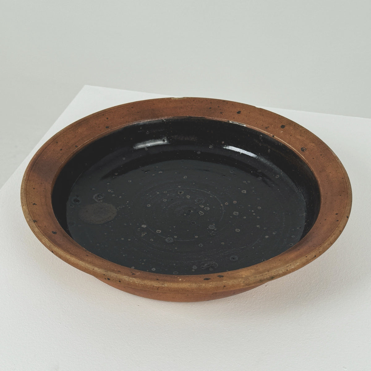 Interior view of Pierre Digan stoneware bowl with dark glaze