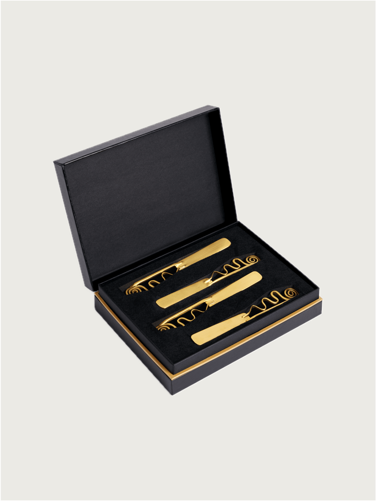 Set of 4 Spirale Spreaders — close-up of gold-toned spreaders in box