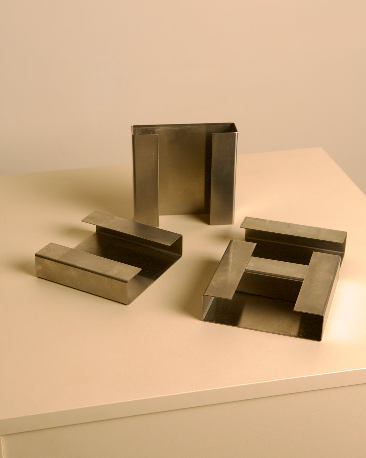 Pair of Italian brushed metal ashtrays by Fontana Arte, 1960s — side angle