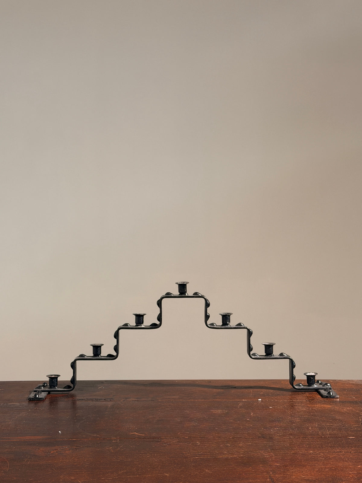 Seven-light geometric candelabra in black iron, circa 1960 — detail view