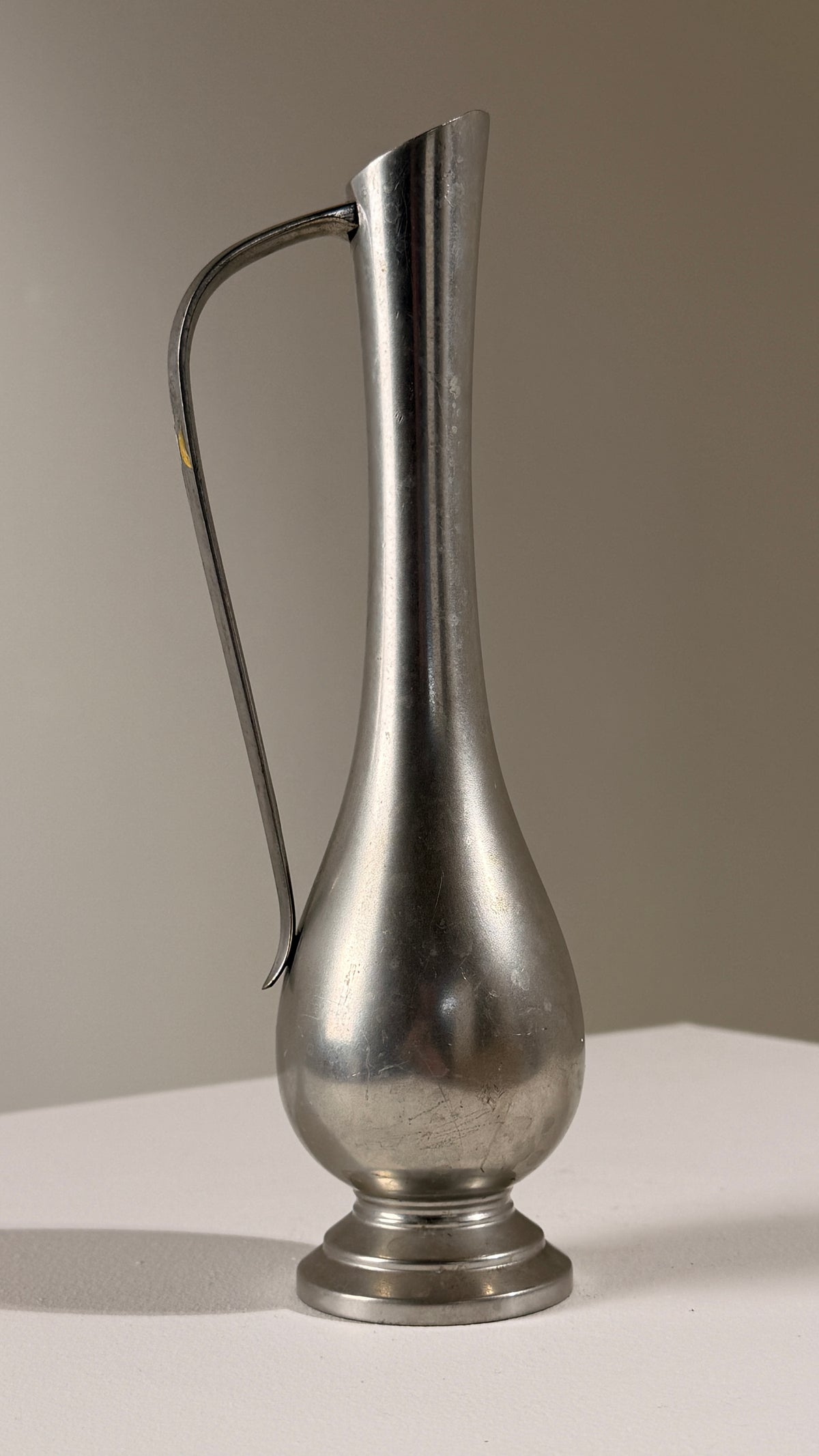 Pewter Pitcher, Paris, France, circa 1930 — angled view on white surface