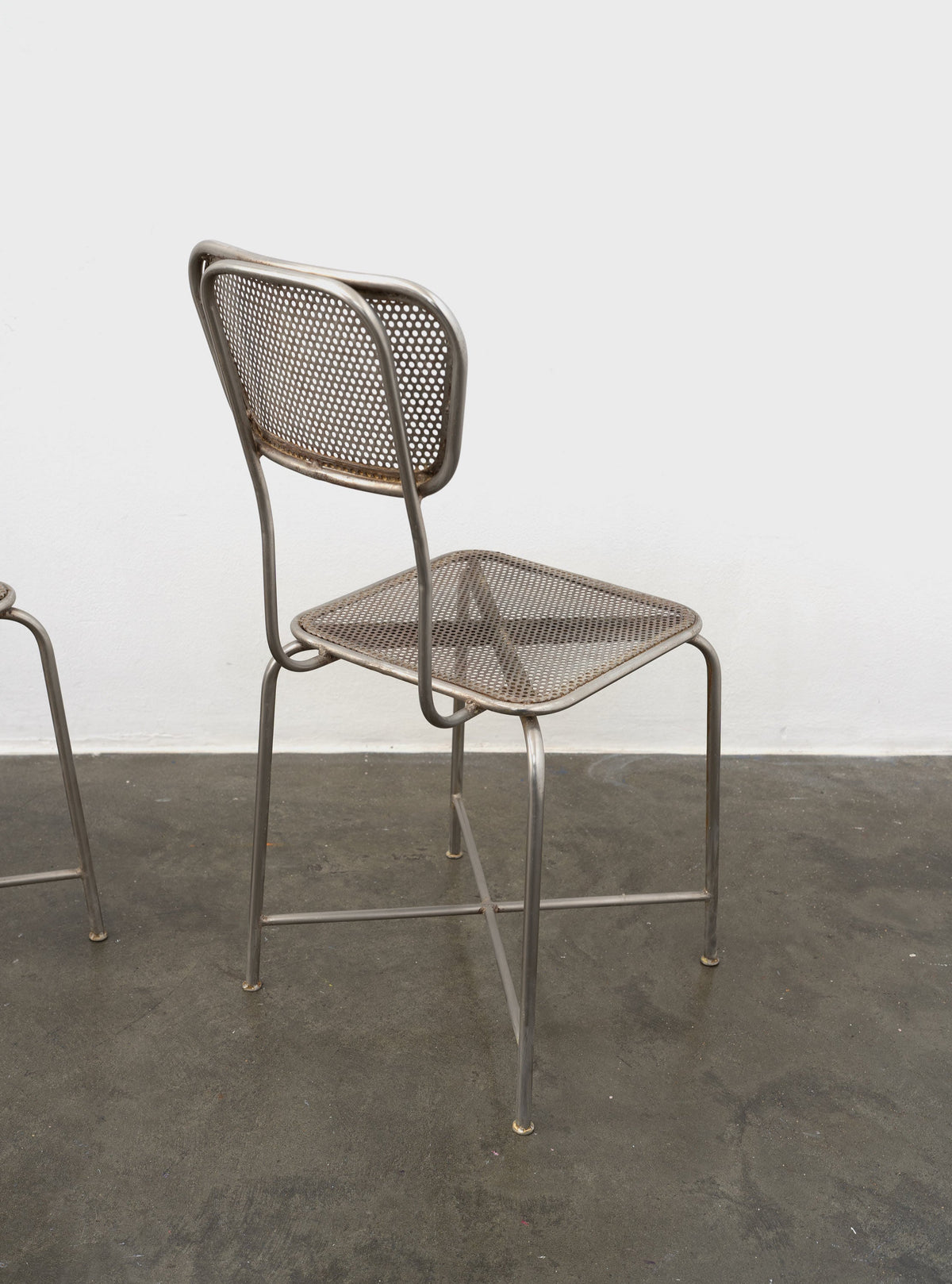 Vintage perforated metal chair back and seat detail view