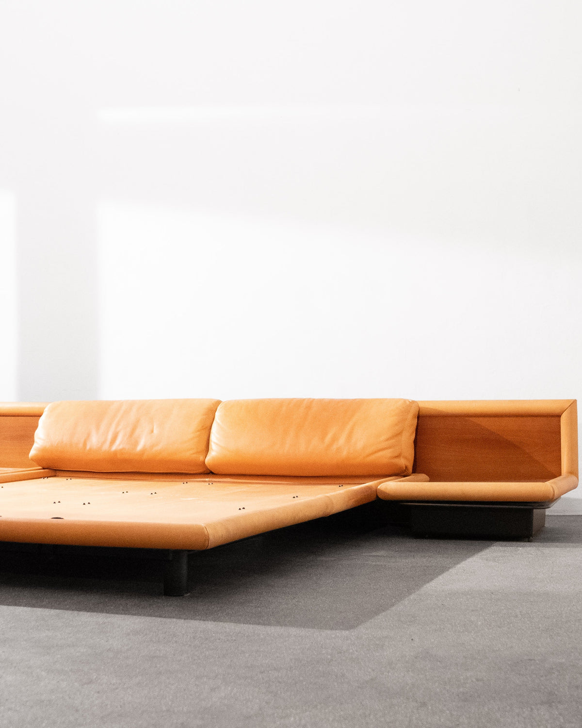 Modern tan leather sectional sofa with low profile design