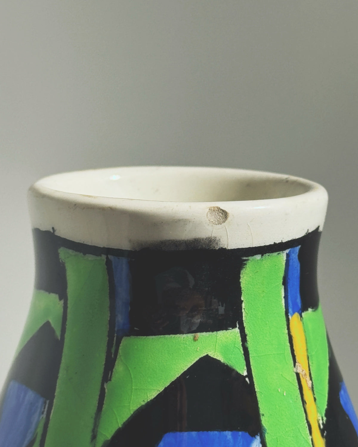 Art Deco vase by Charles Catteau showing colorful geometric rim detail