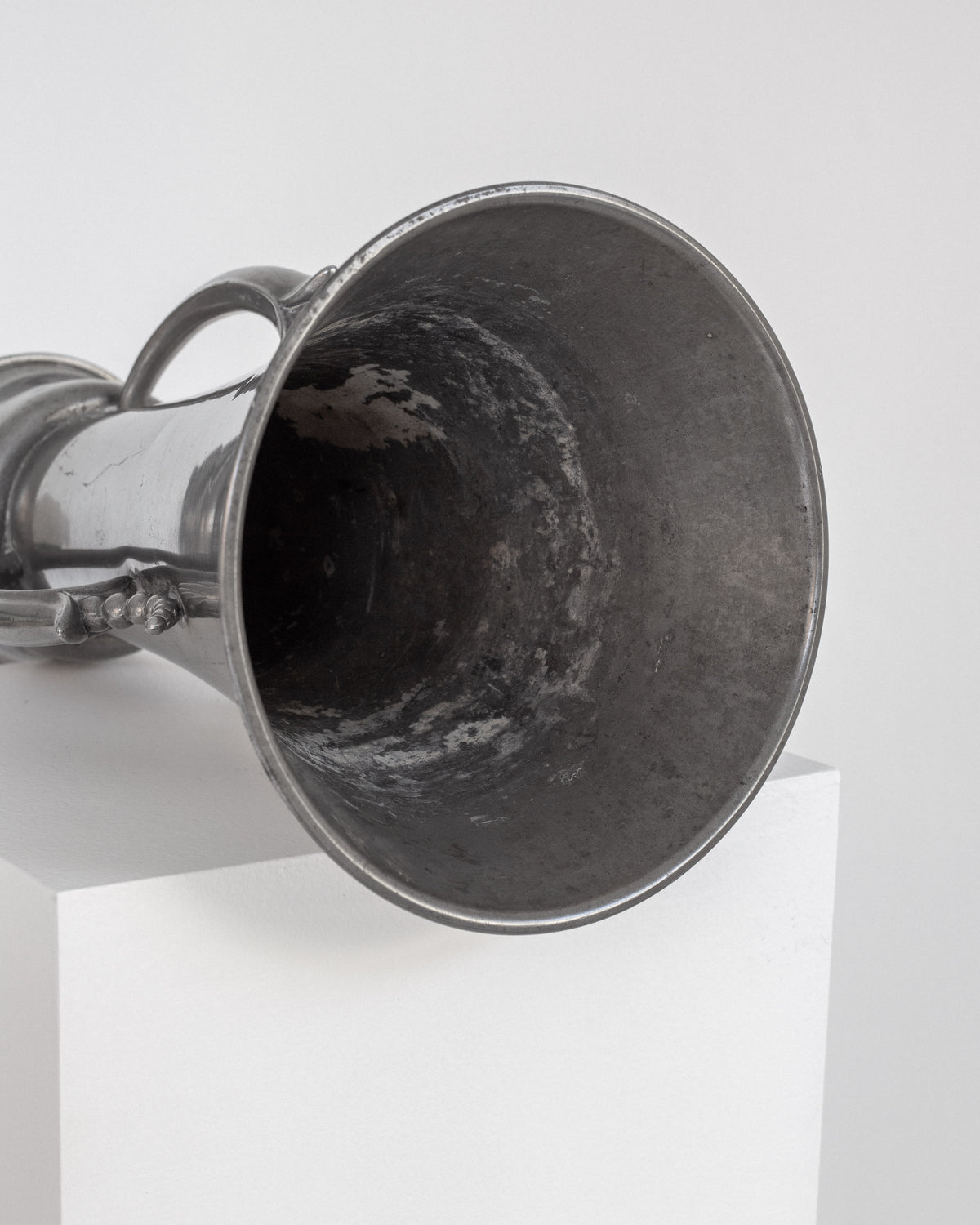Interior view of Art Deco pewter vase showing curved form and patina