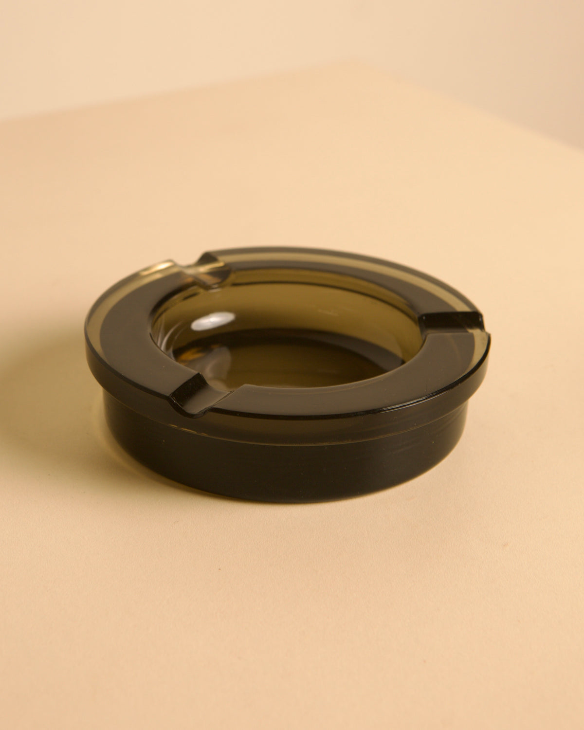 Italian circular metal and amber glass ashtray, 1970s — close-up