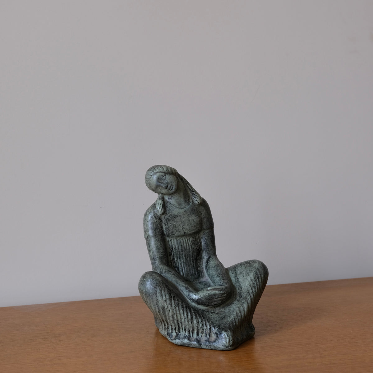 Fidel Aguilar Marco Ceramic Sculpture | Spain | 1930s — close-up of green ceramic figure on wooden surface