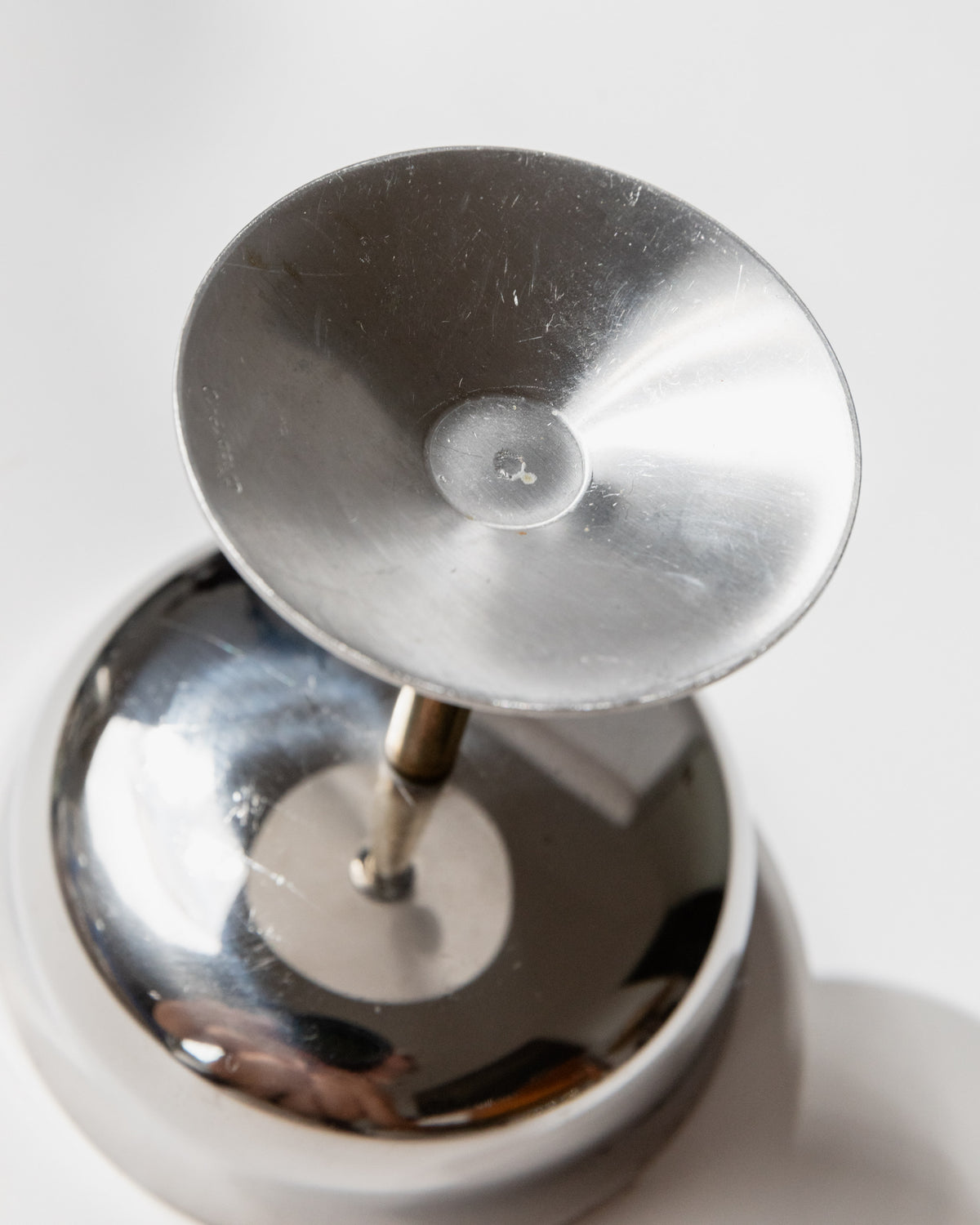 Detail view of golden stem and base of vintage champagne coupe