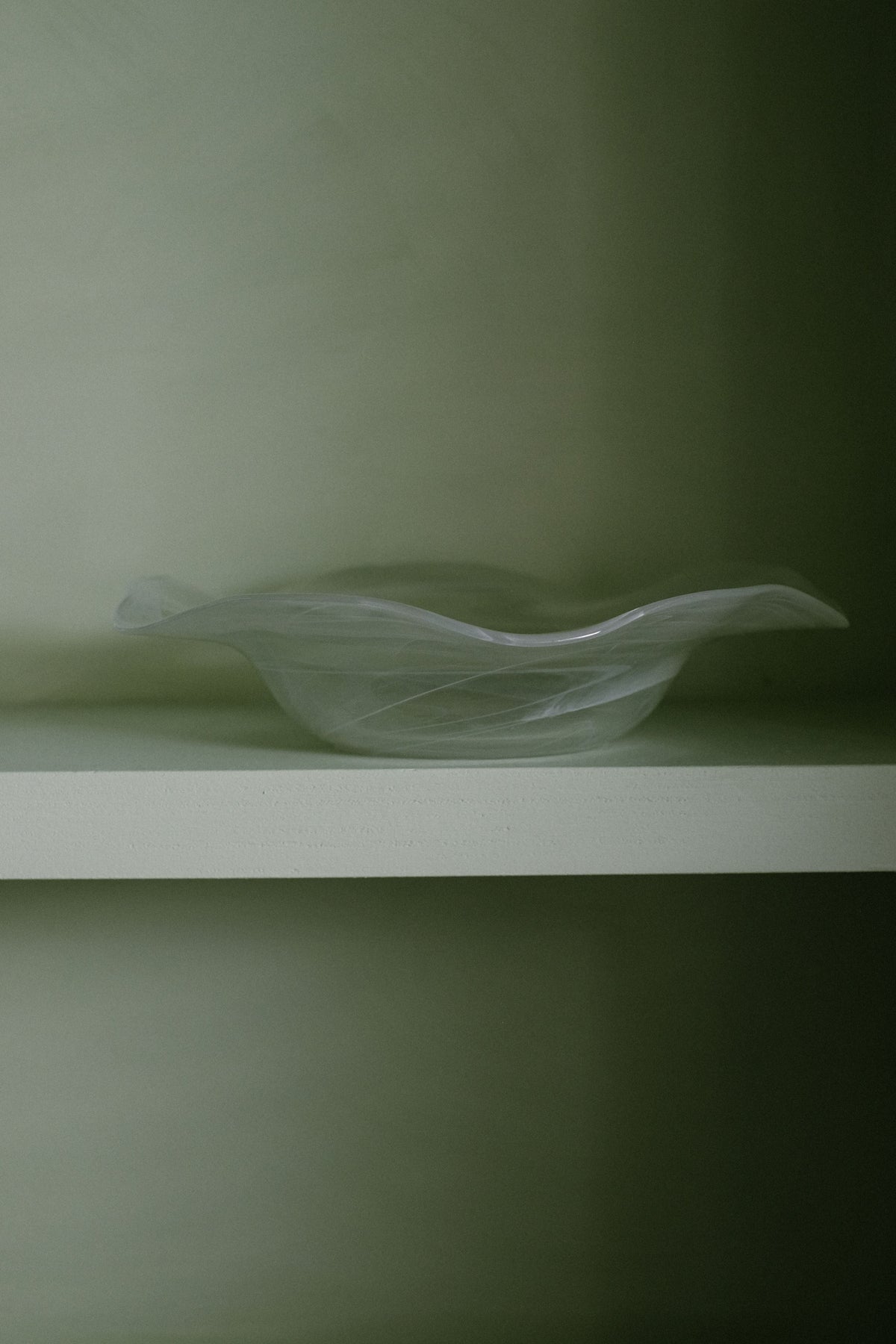 Swirl Glass Bowl — top view on light green shelf