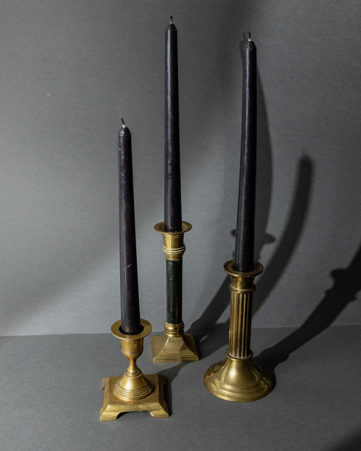 Vintage 1940s Brass Candleholders Set of 3, Mixed Shapes, Classic Antique Design — close-up of three brass candleholders with
