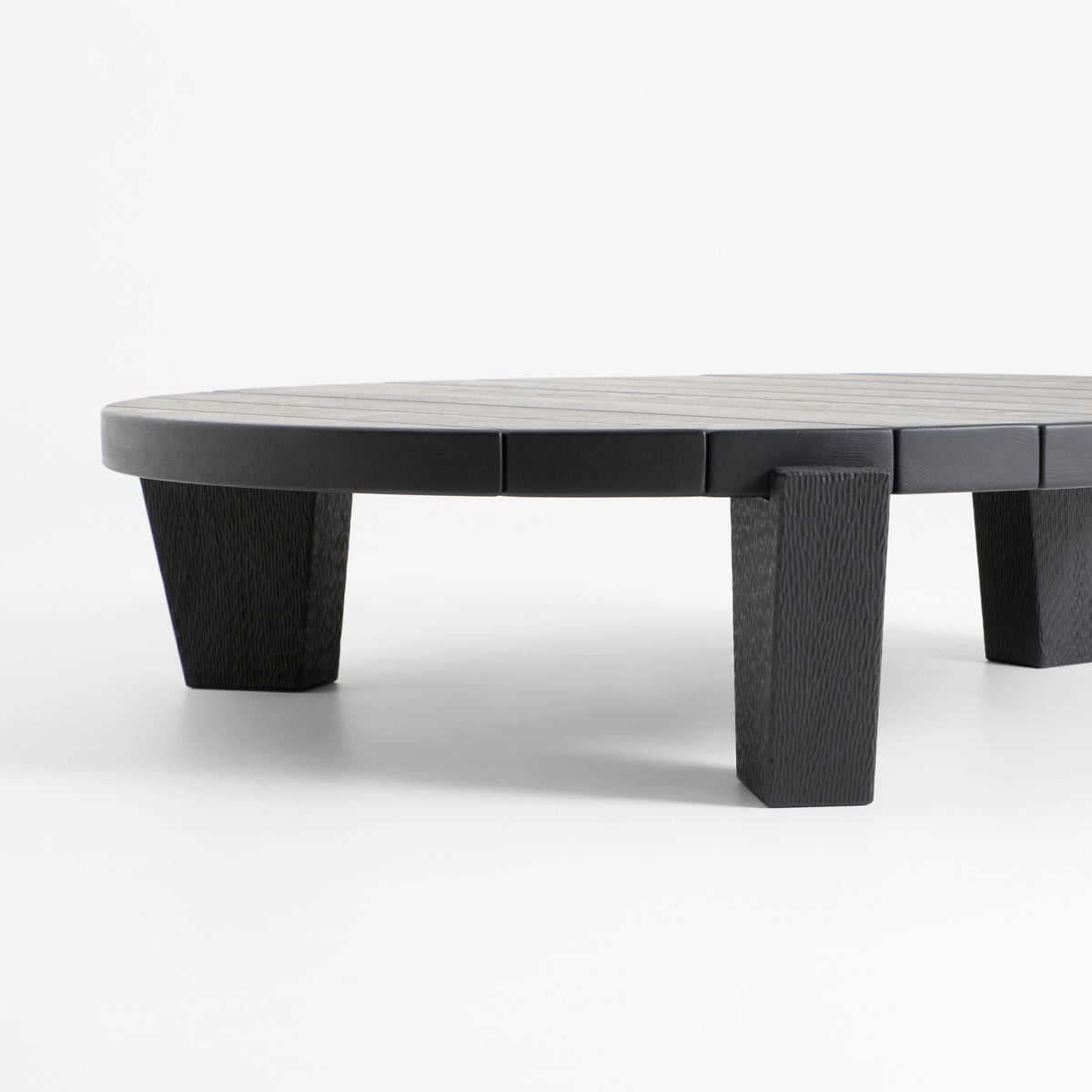 Peniche Coffee Table in Oak — side view highlighting textured black legs